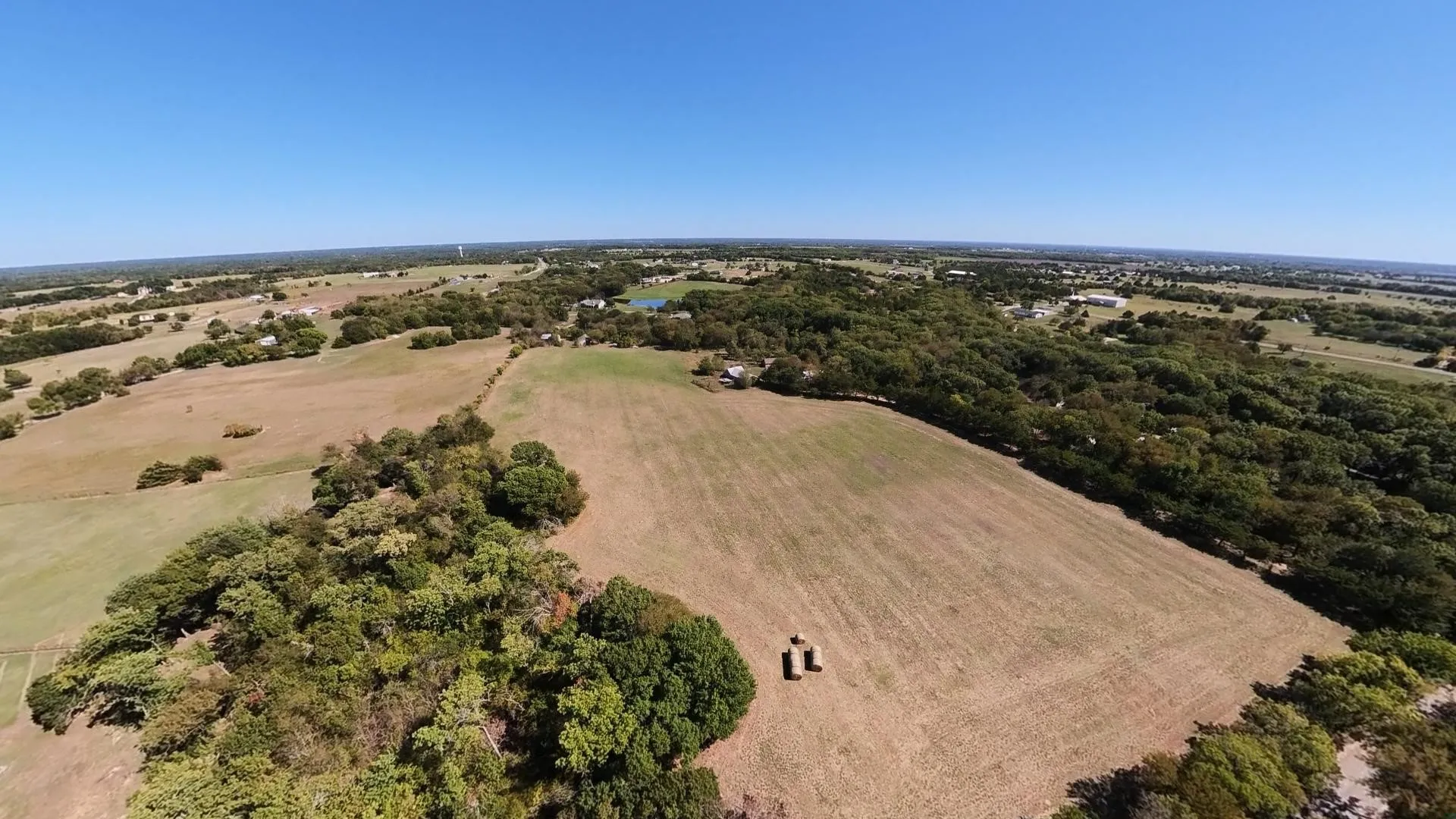 Expansive open fields with scattered trees and natural landscaping