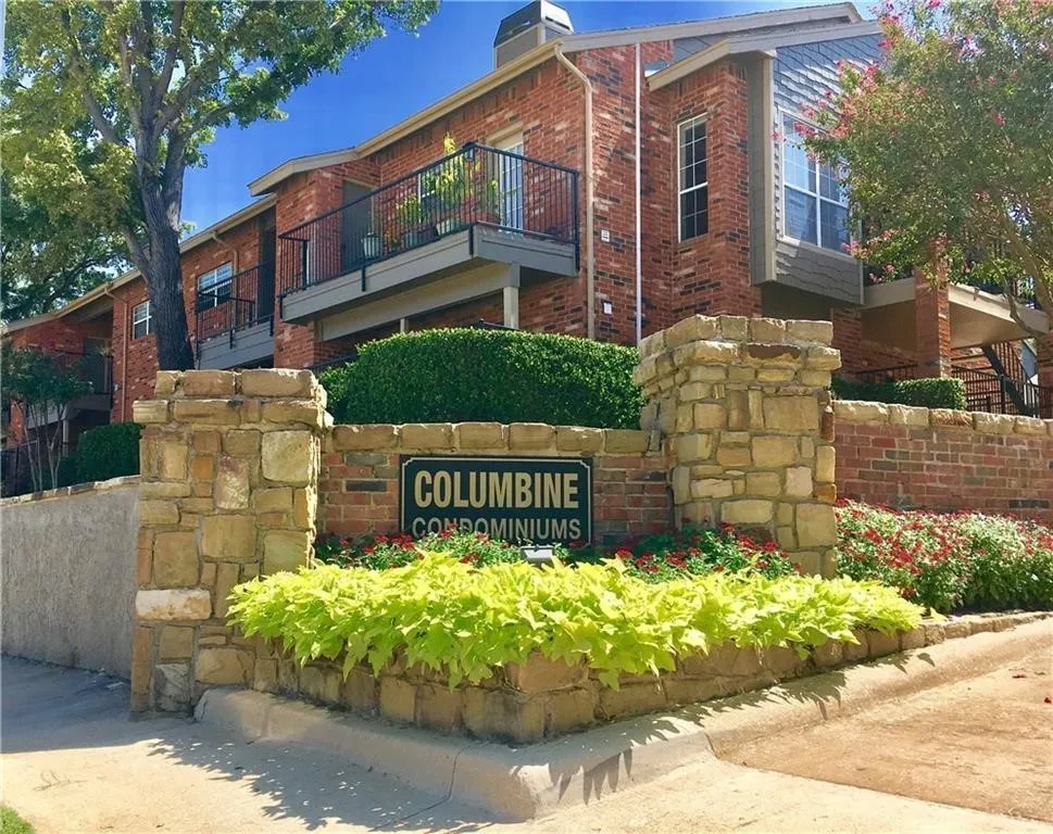 Brick exterior with stone accents and black wrought iron railings