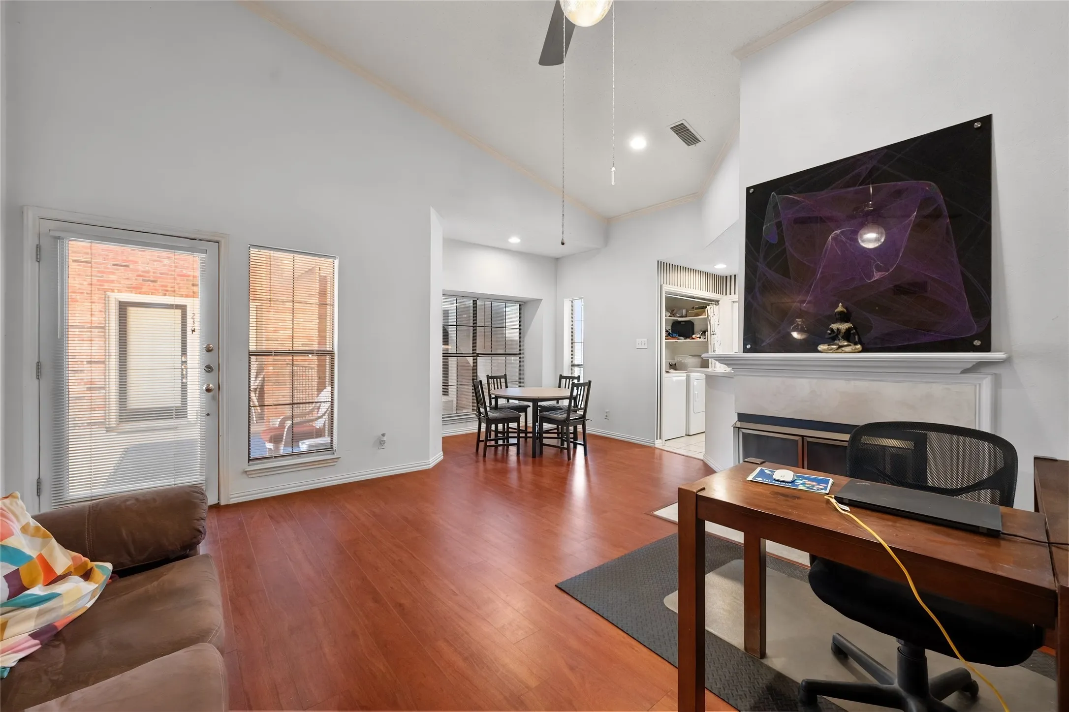 Vaulted ceiling with a ceiling fan, recessed lighting and wood floors