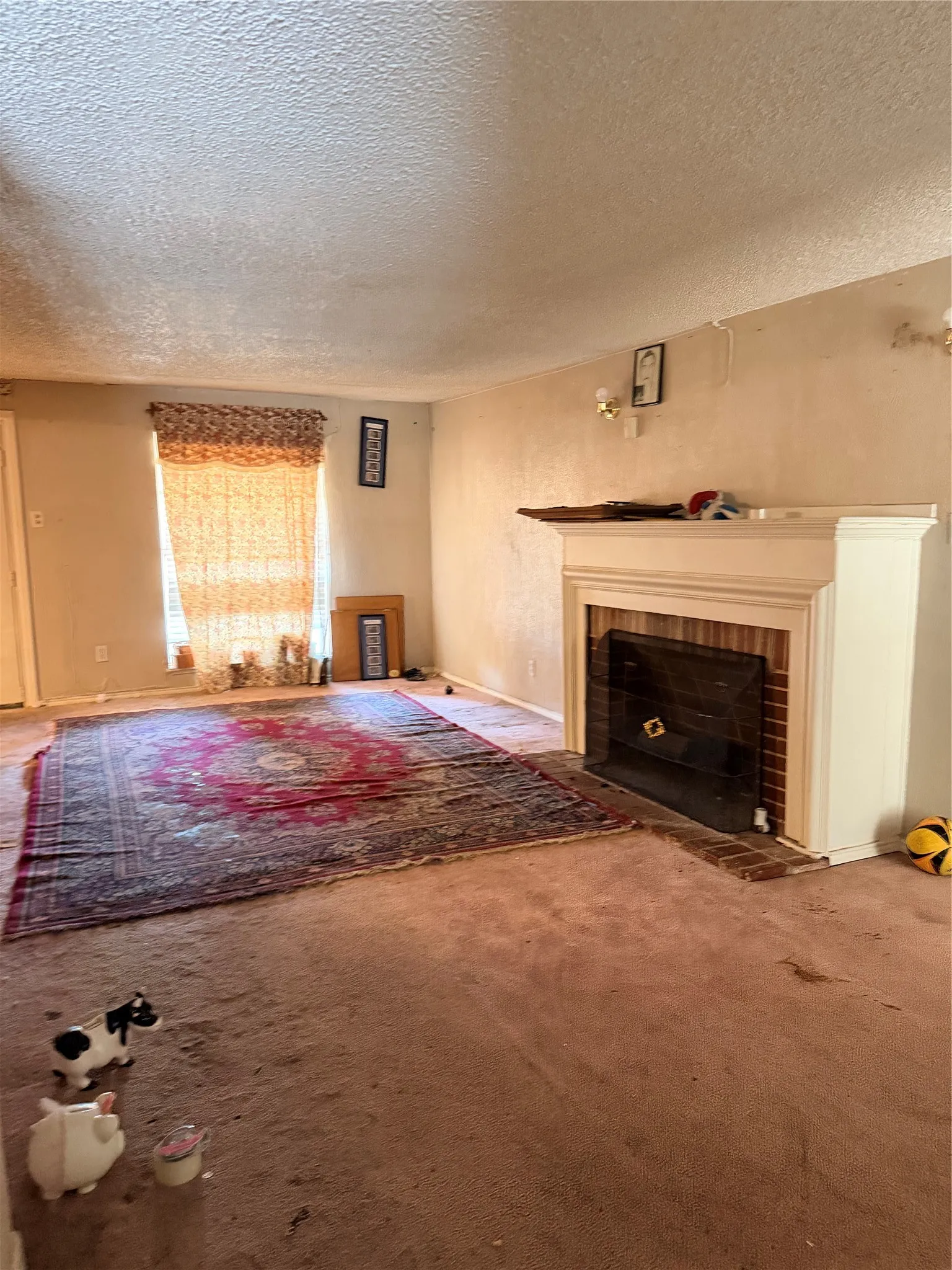 Built-in fireplace featuring a brick surround and a white mantelpiece
