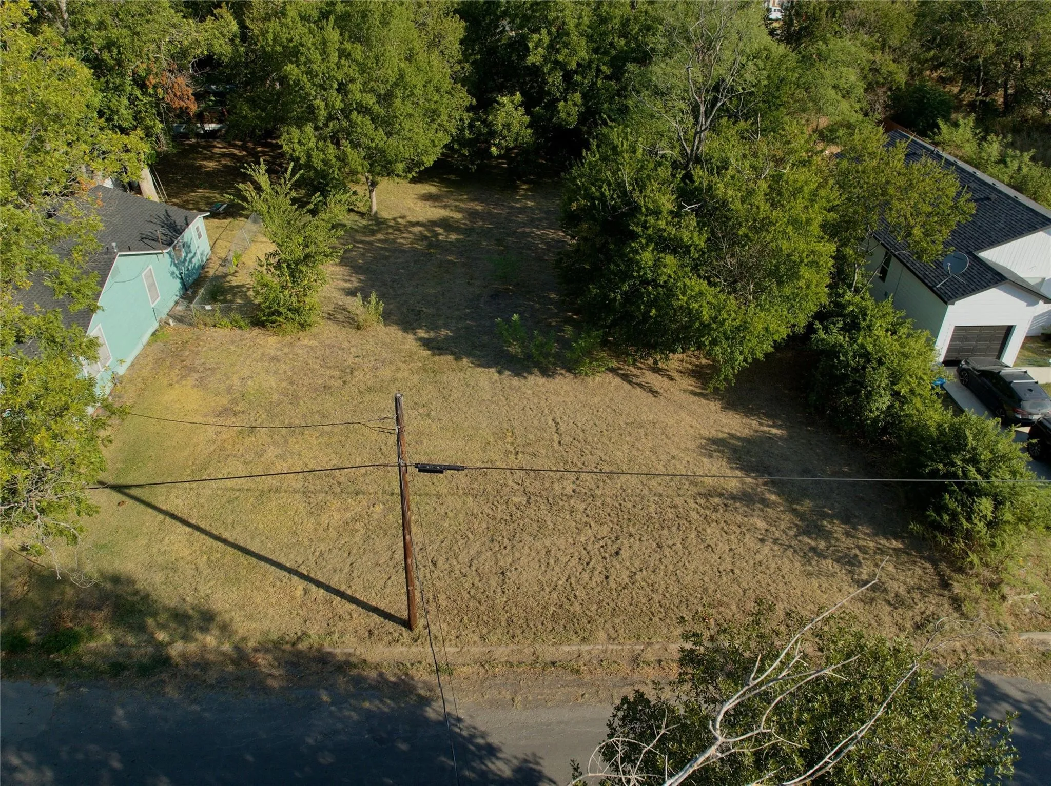Expansive lot with mature trees and direct road frontage