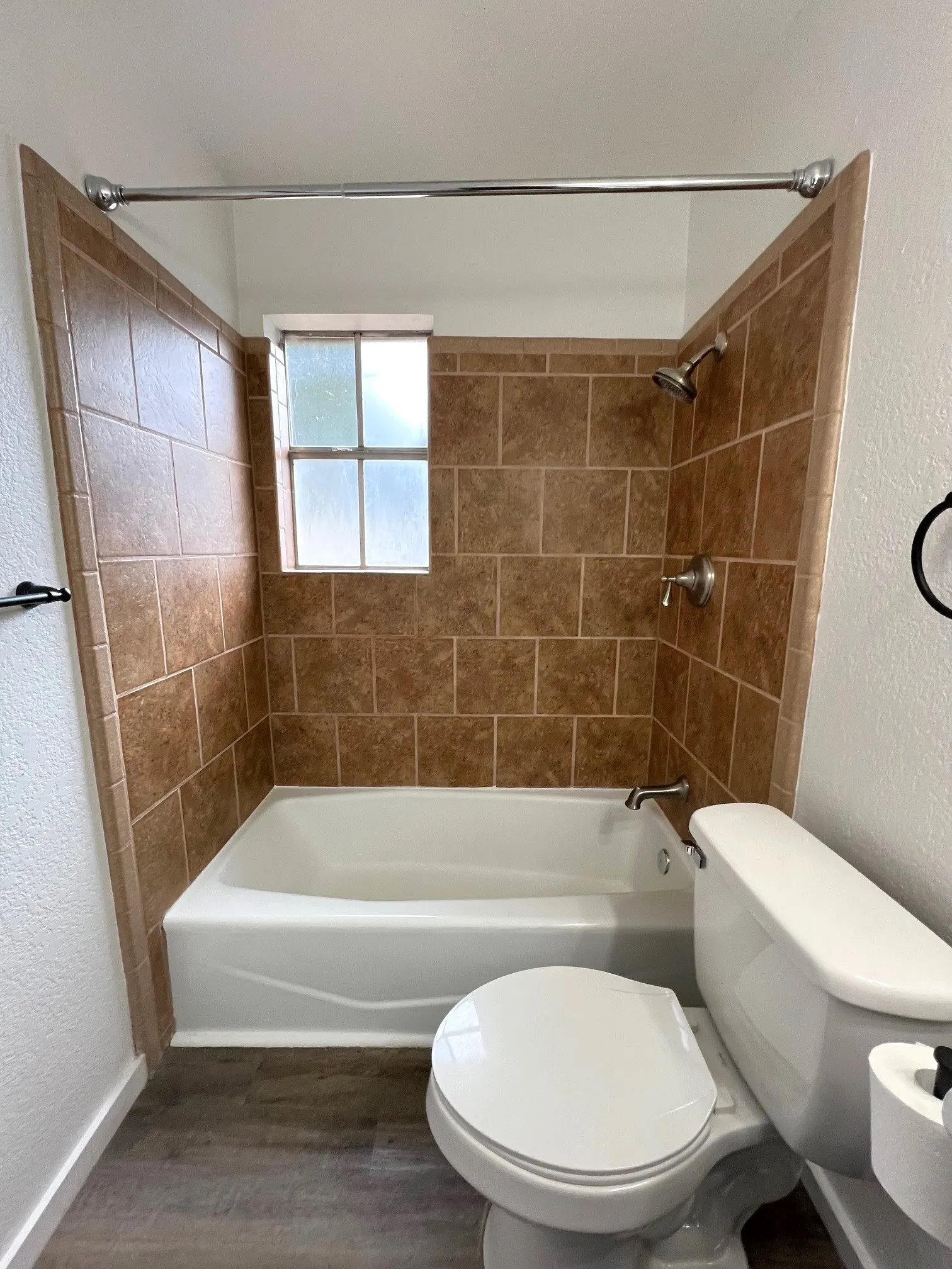 Primary Bathroom featuring tiled shower and tub