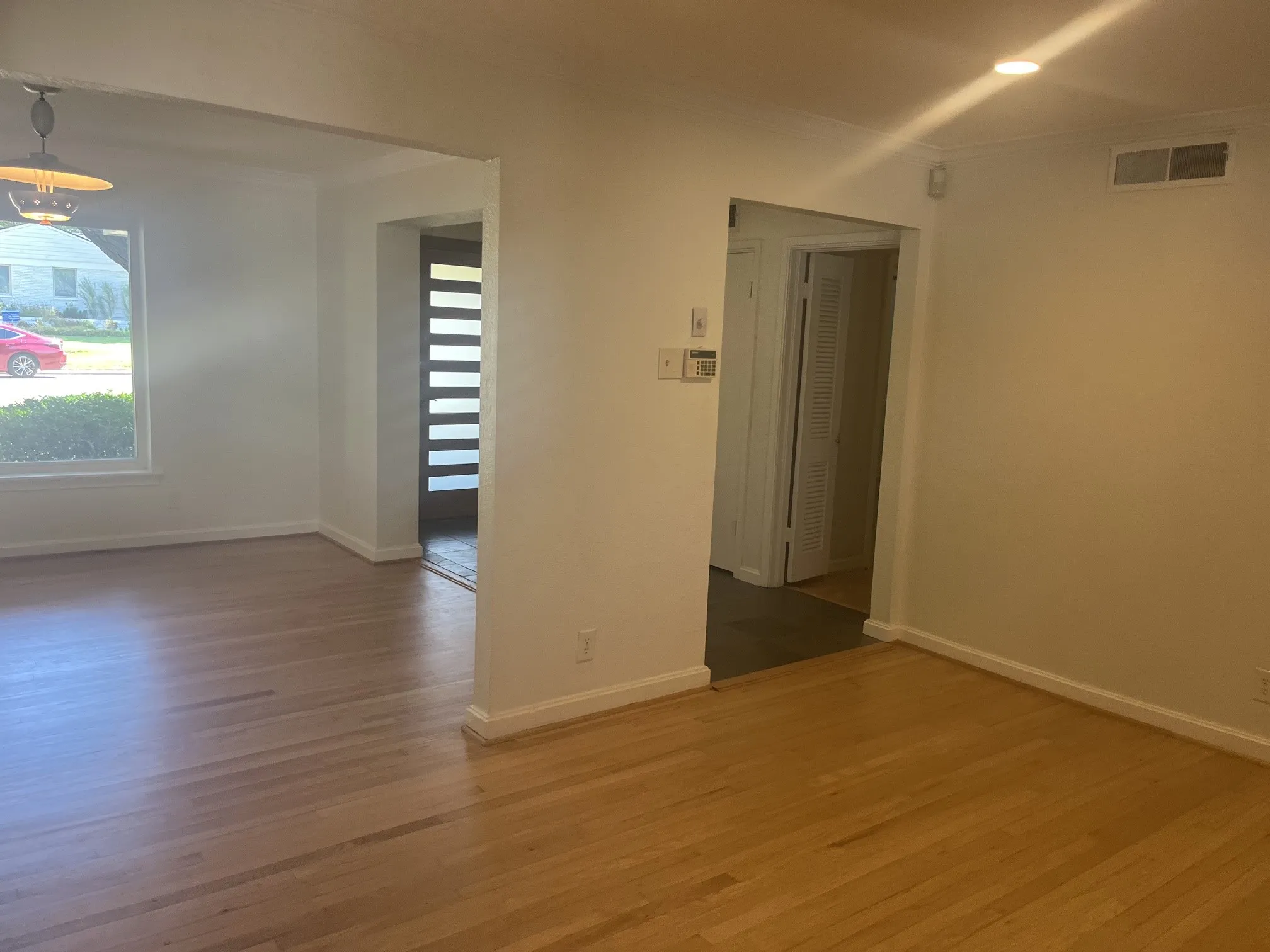 Hardwood flooring, recessed lighting, and a modern entry door with frosted glass panels