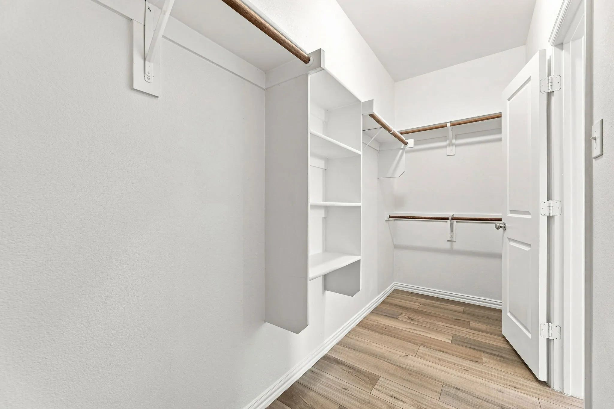 Primary bedroom walk in closet
