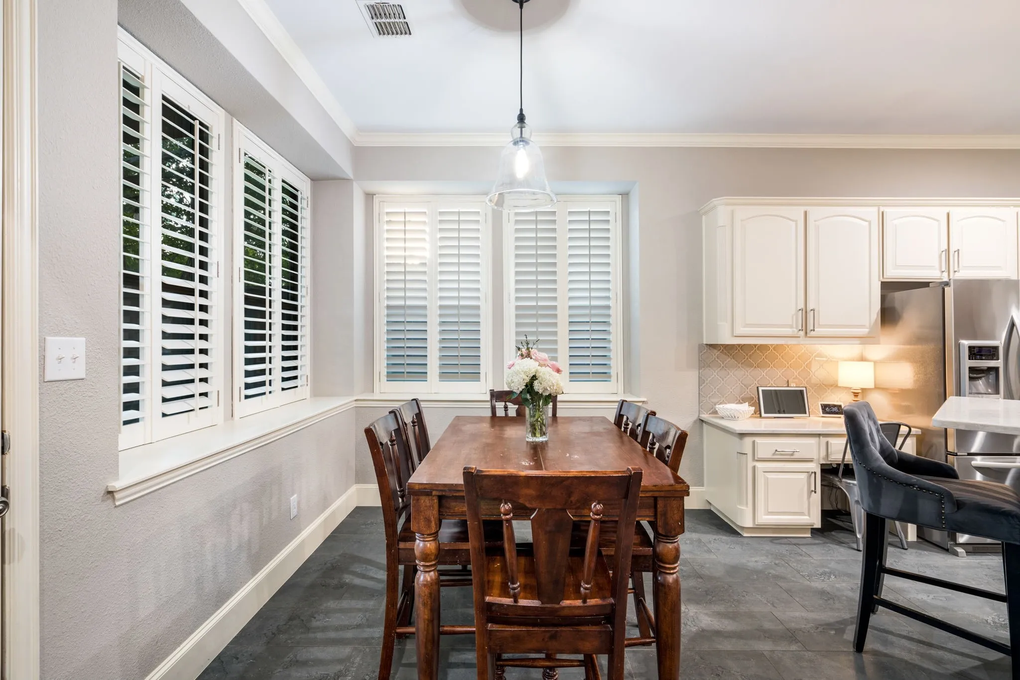 kitchen /nook area with updated flooring and bench seating around for larger family use