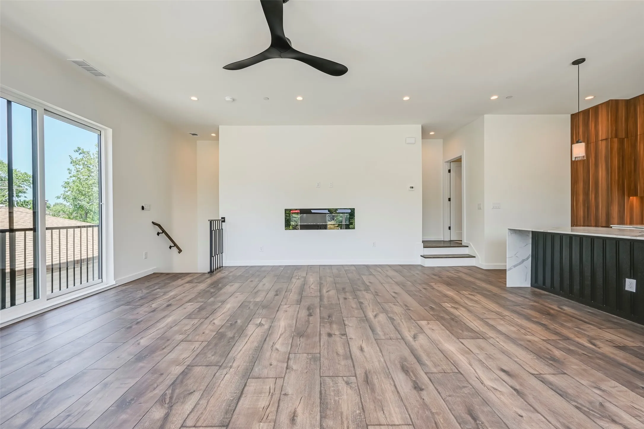Wood-finish flooring, recessed lighting, and a modern ceiling fan