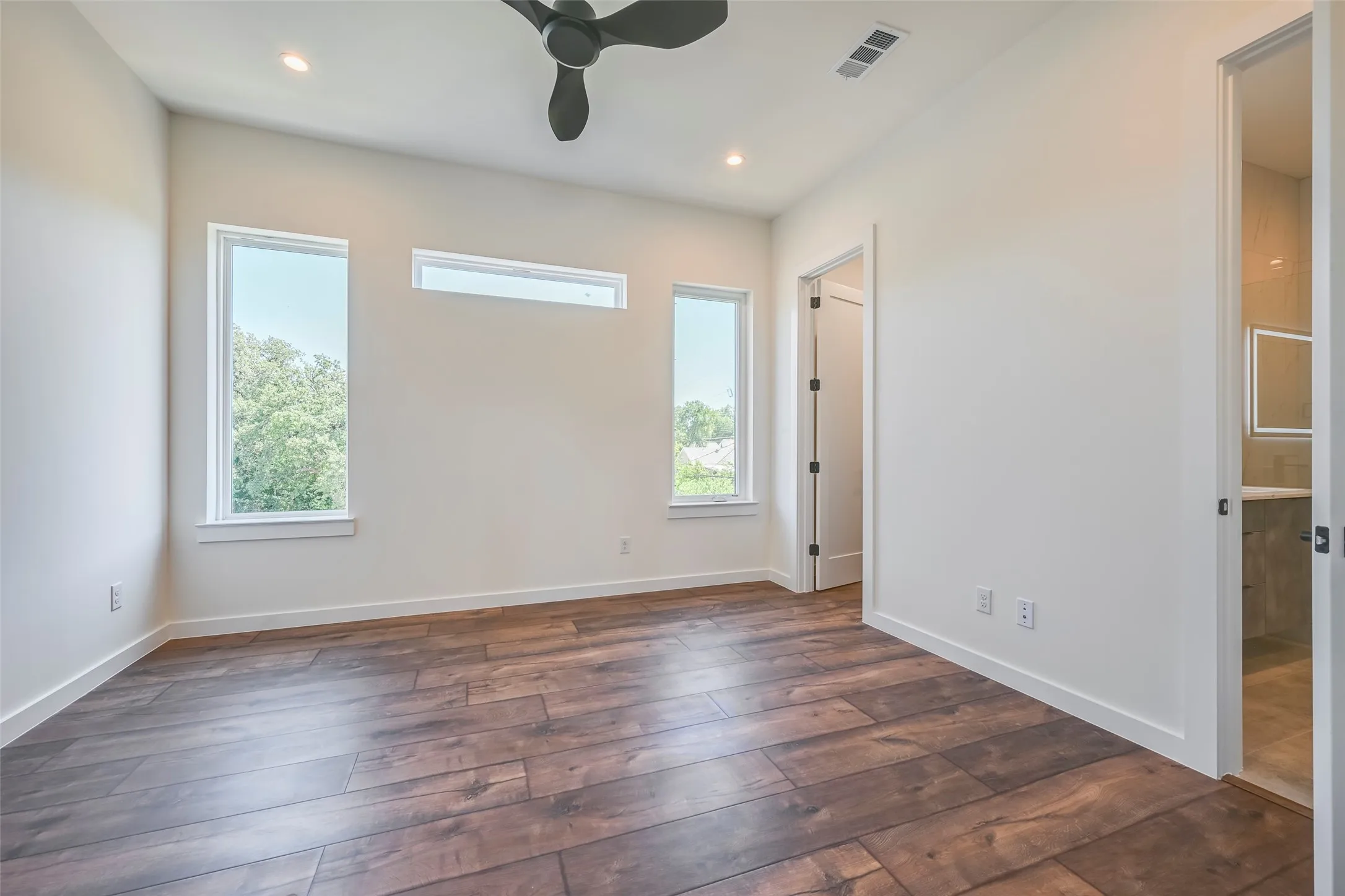 Wood-finish flooring, recessed lighting, and a ceiling fan