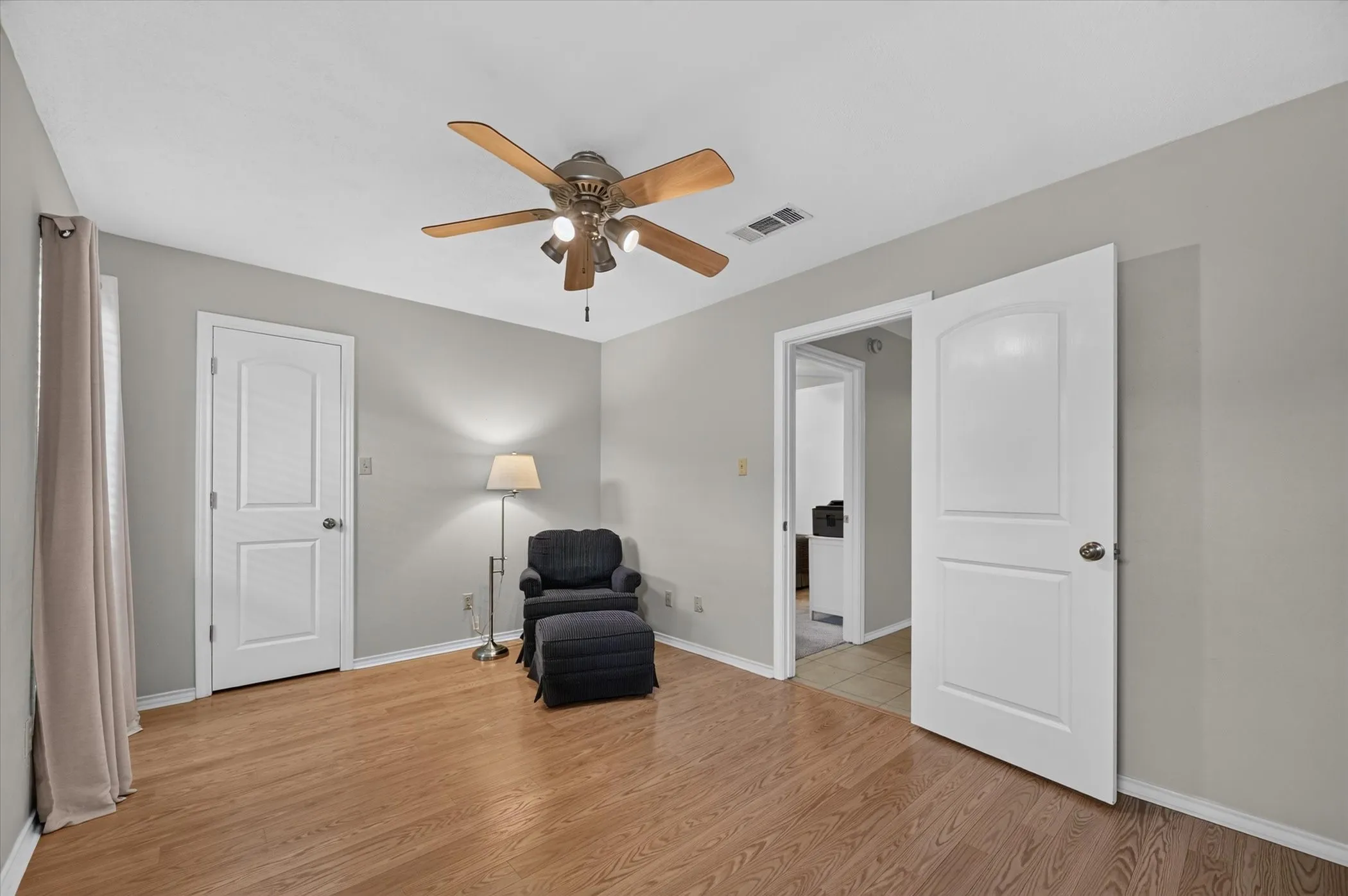 Another view of the downstairs secondary bedroom that has wood floors.