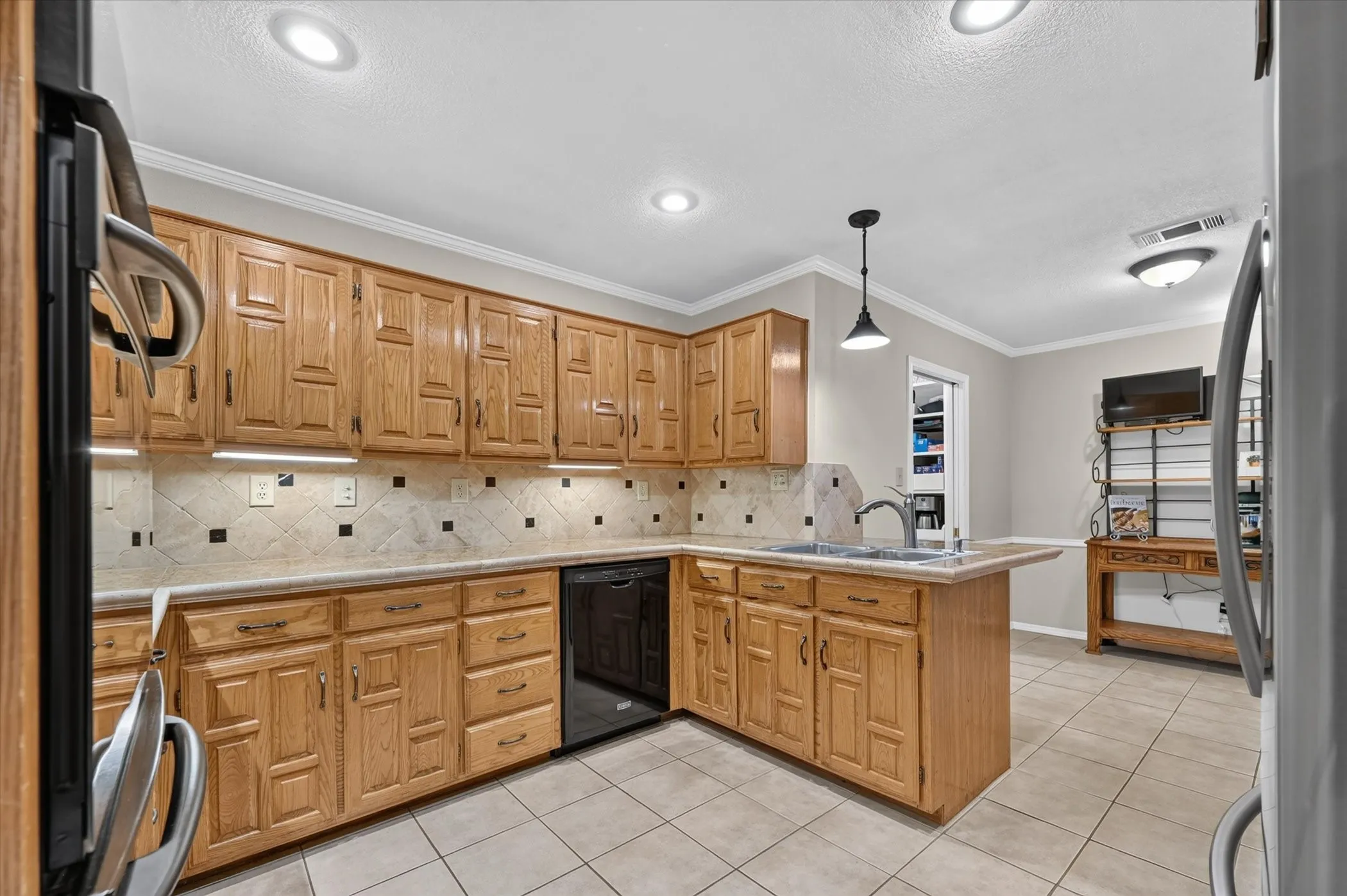 The kitchen has plenty of cabinets for storage.