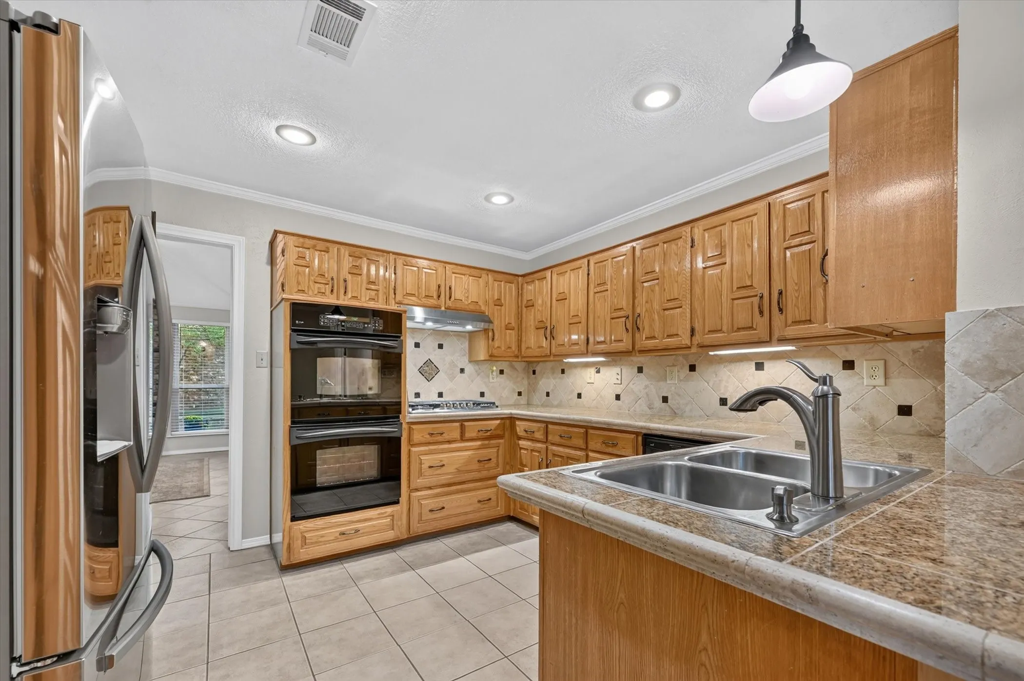 Who doesn't want double ovens for cooking when you are having a large gathering. The kitchen looks into the family room.