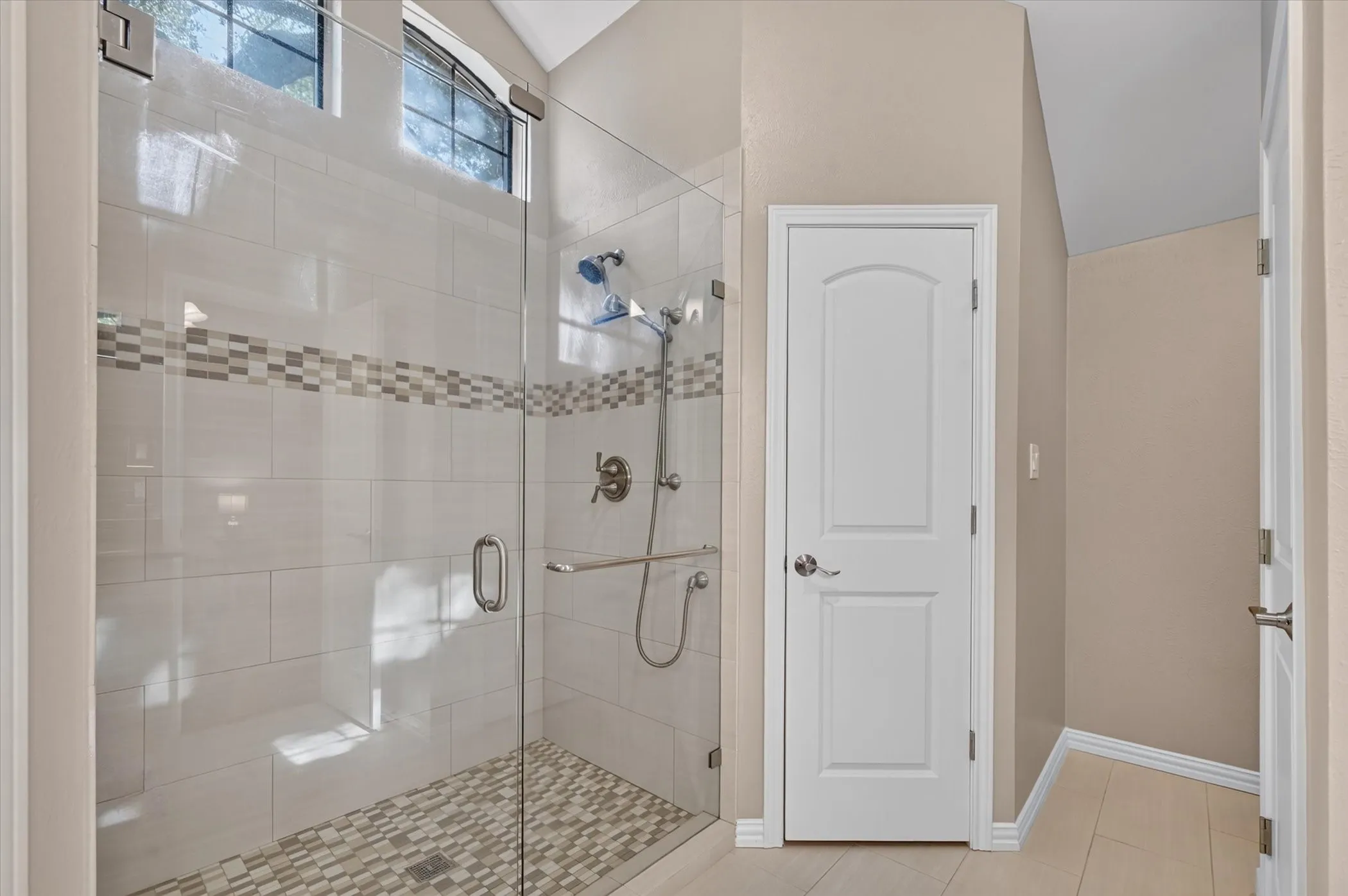 The updated primary bathroom has a large walk in shower.
