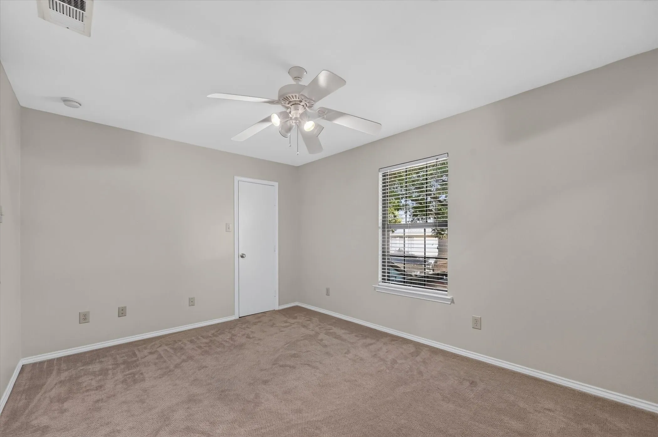 One of two secondary upstairs bedrooms with a ceiling fan, walk in closet and upgraded carpet.