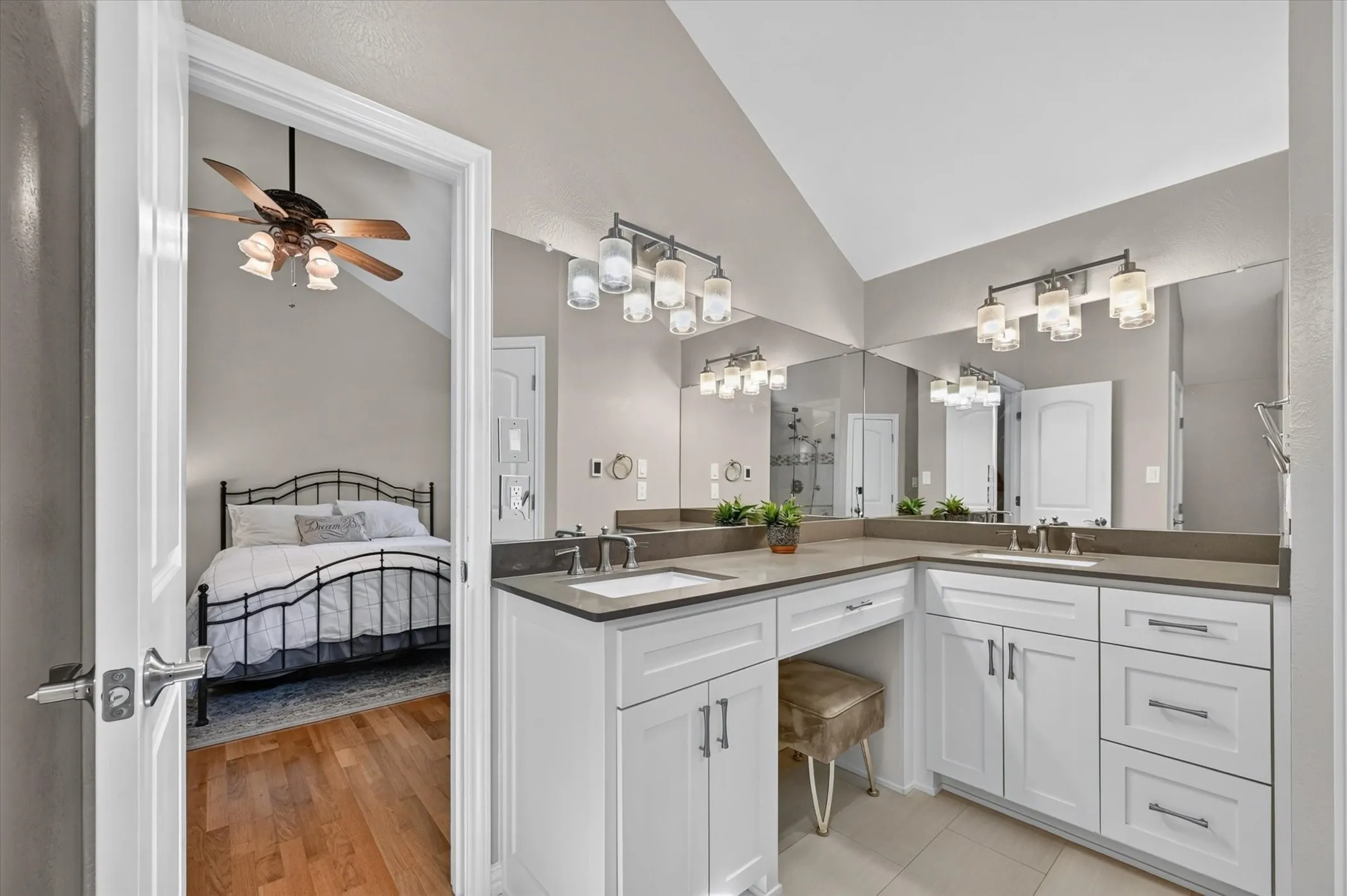 The primary bathroom has been updated and has double sinks, cabinets with drawers, pretty lighting and heated floors.