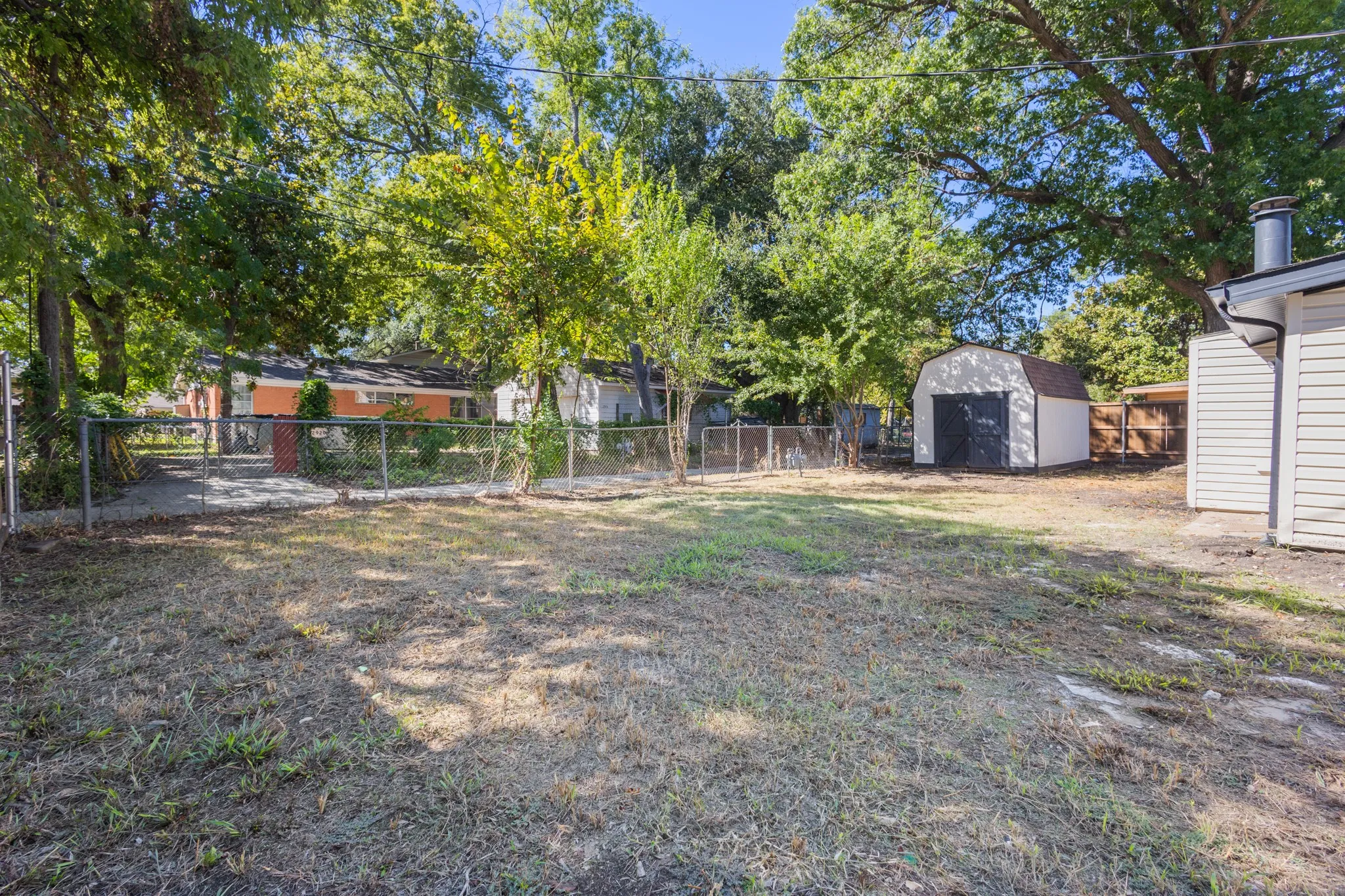 Expansive yard with fenced perimeter, and a detached storage shed