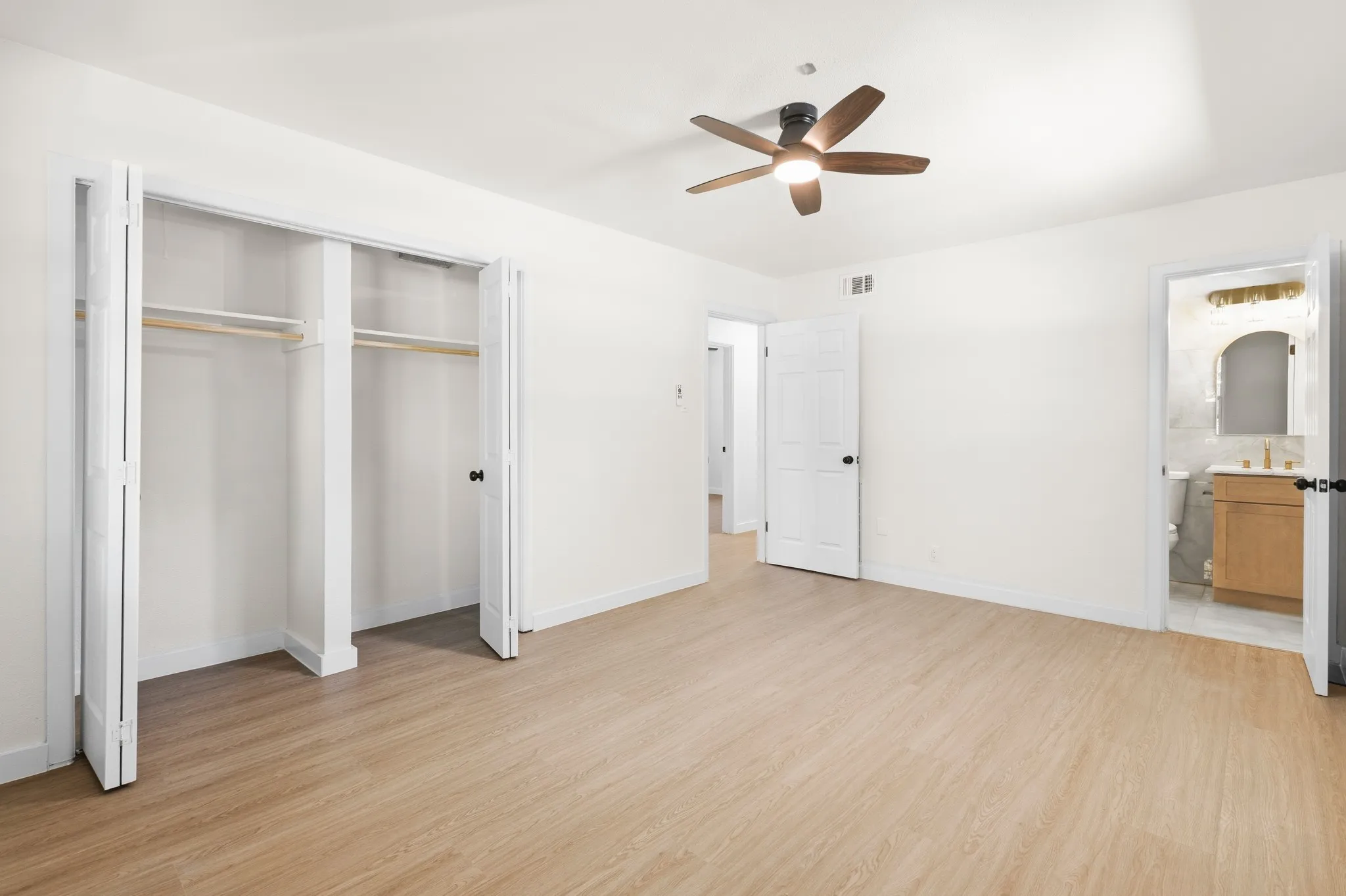 Master bedroom with ceiling fan with light, bi-fold closet doors, highly upgraded attached bathroom