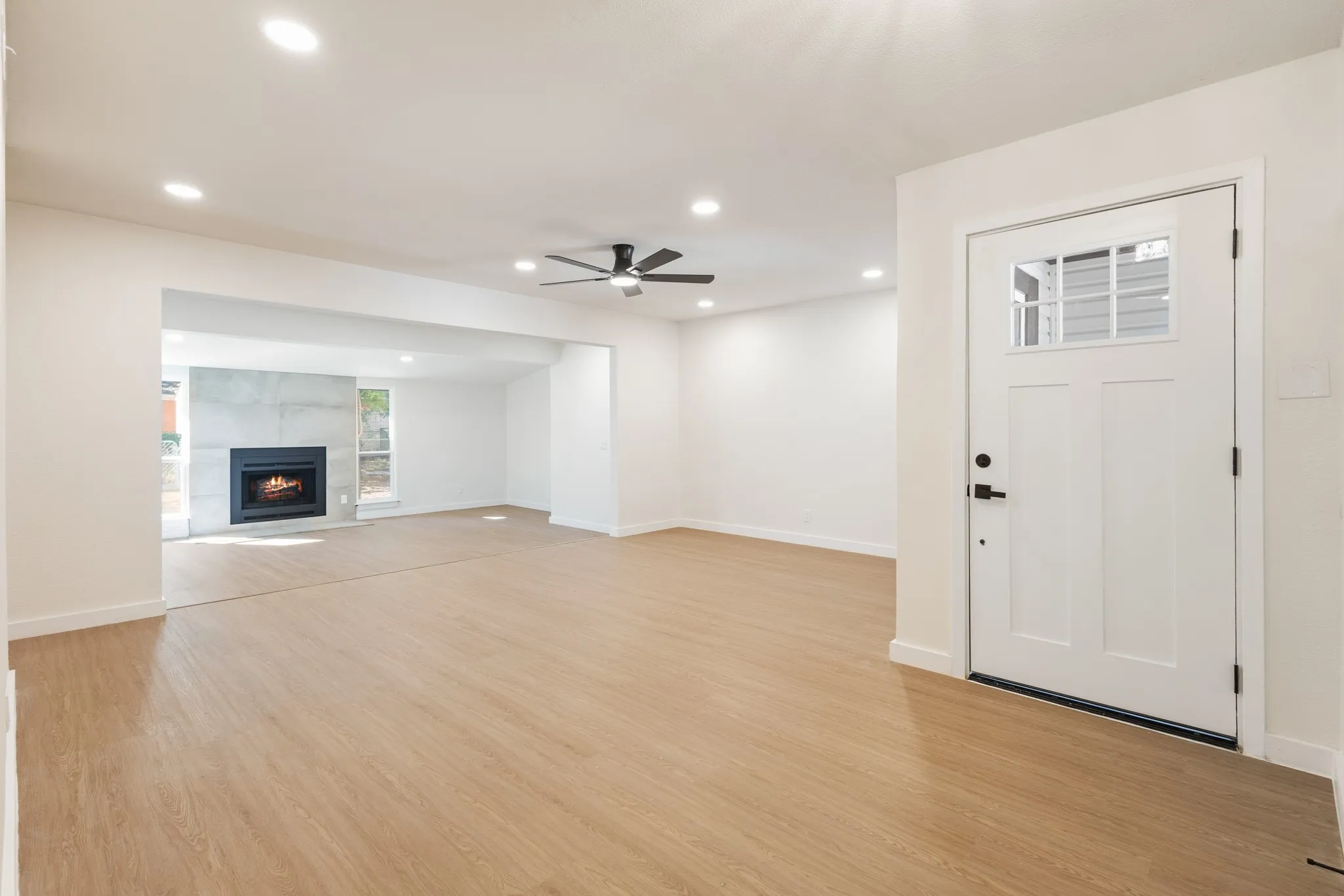 Living room and family room with durable Water & scratch proof flooring, can lighting throughout, modern ceiling fan