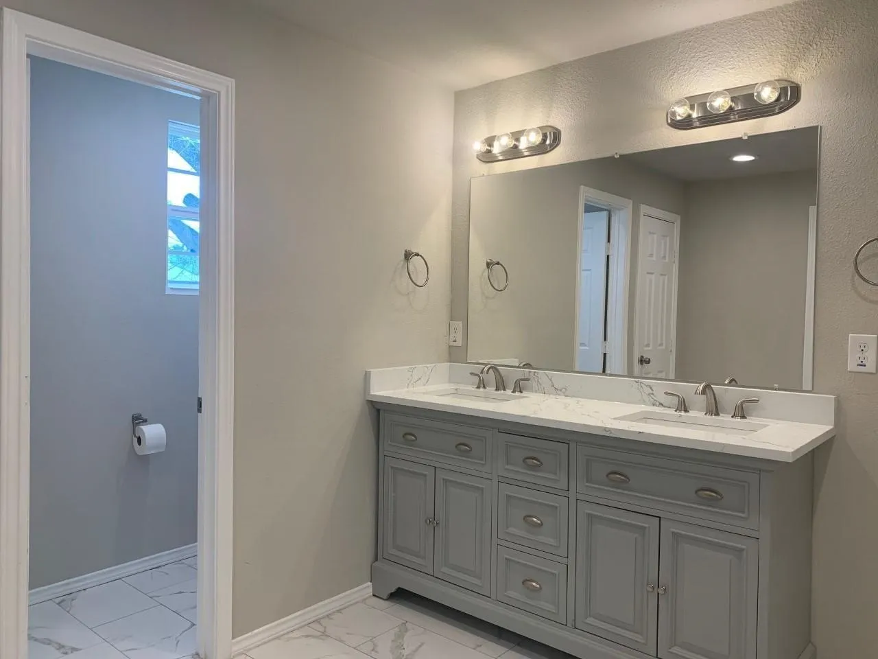 Dual vanity with stone-finish countertop, two undermount sinks, and brushed nickel fixtures