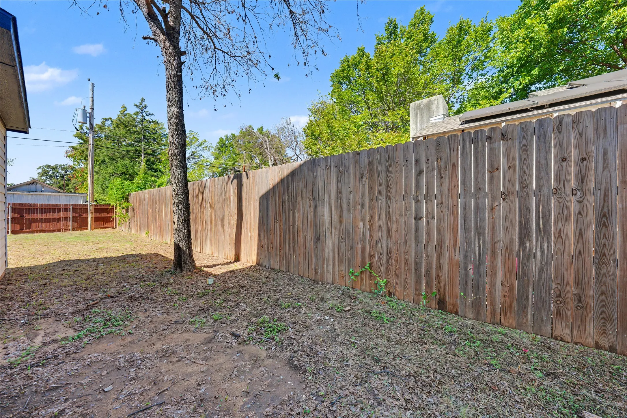 Side of yard featuring a wood privacy fence.