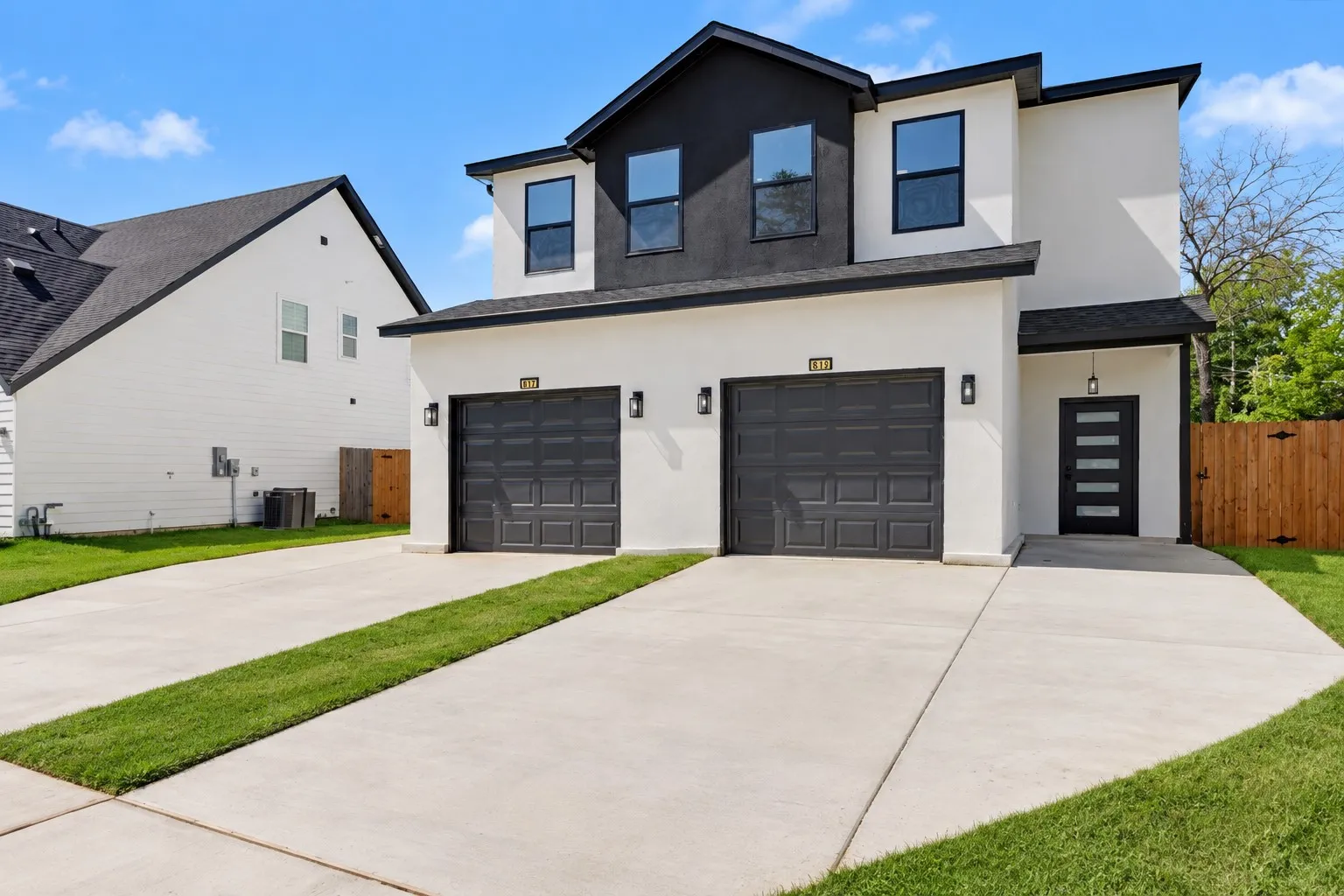 Contemporary exterior with a white stucco finish and black accents