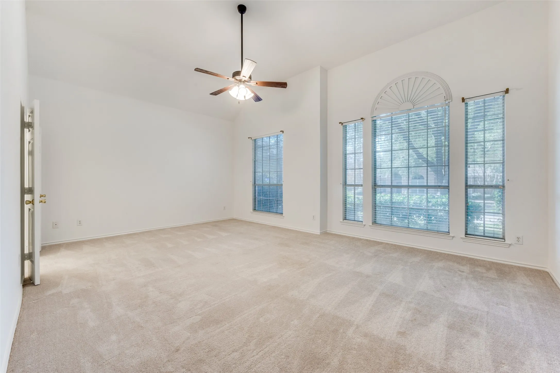 Vaulted ceilings and light-colored carpeting