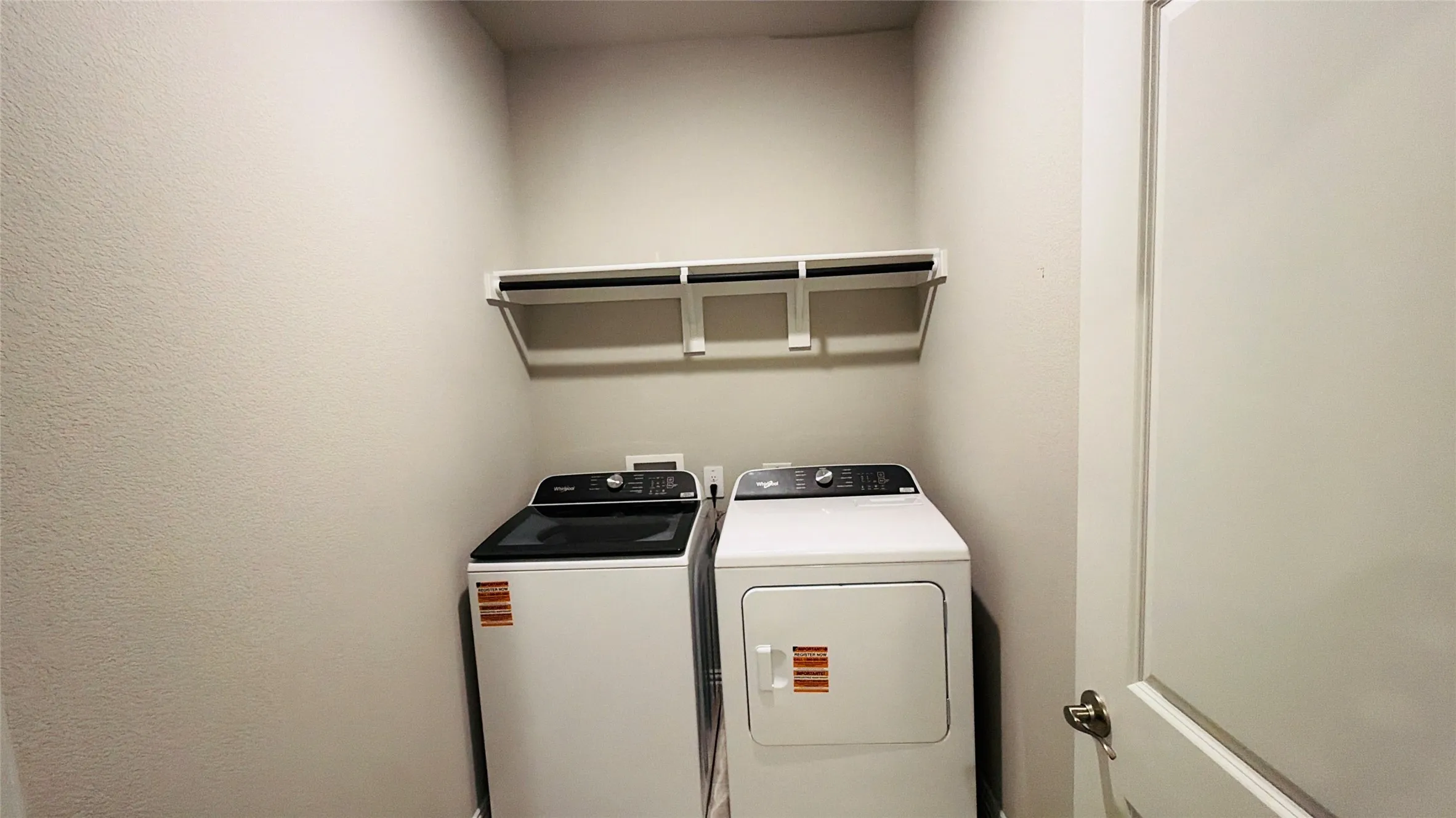 Laundry area with built-in shelving and hanging rod