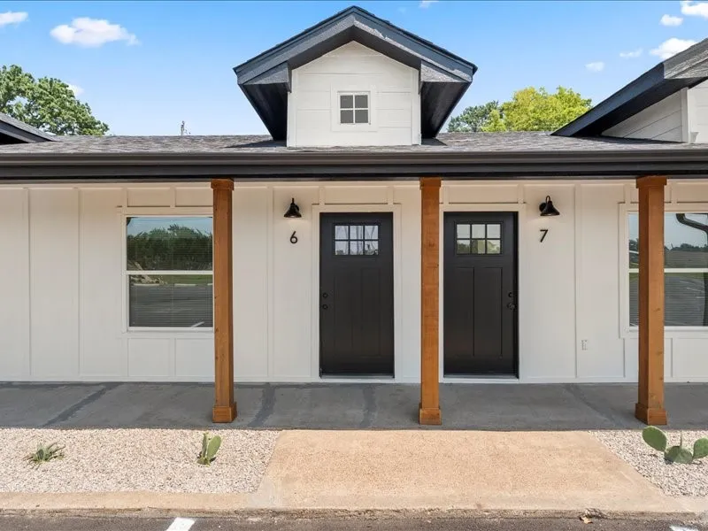 White vertical siding exterior with black trim