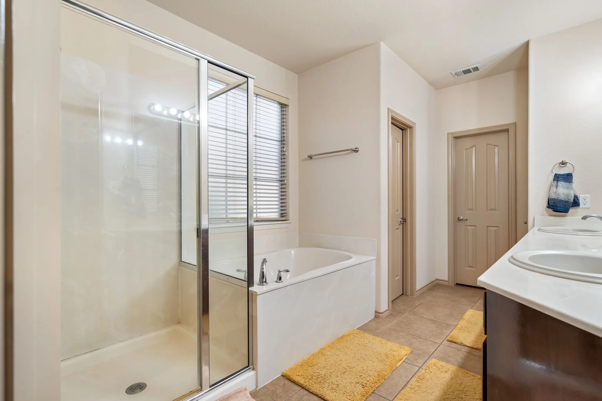 En-suite Primary Bathroom with both standing shower & garden tub, dual sinks, private toilet