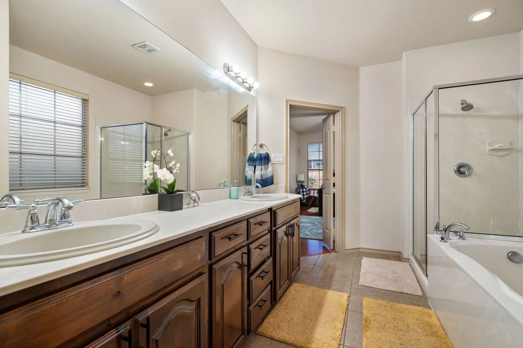En-suite Primary Bathroom with both standing shower & garden tub, dual sinks, private toilet