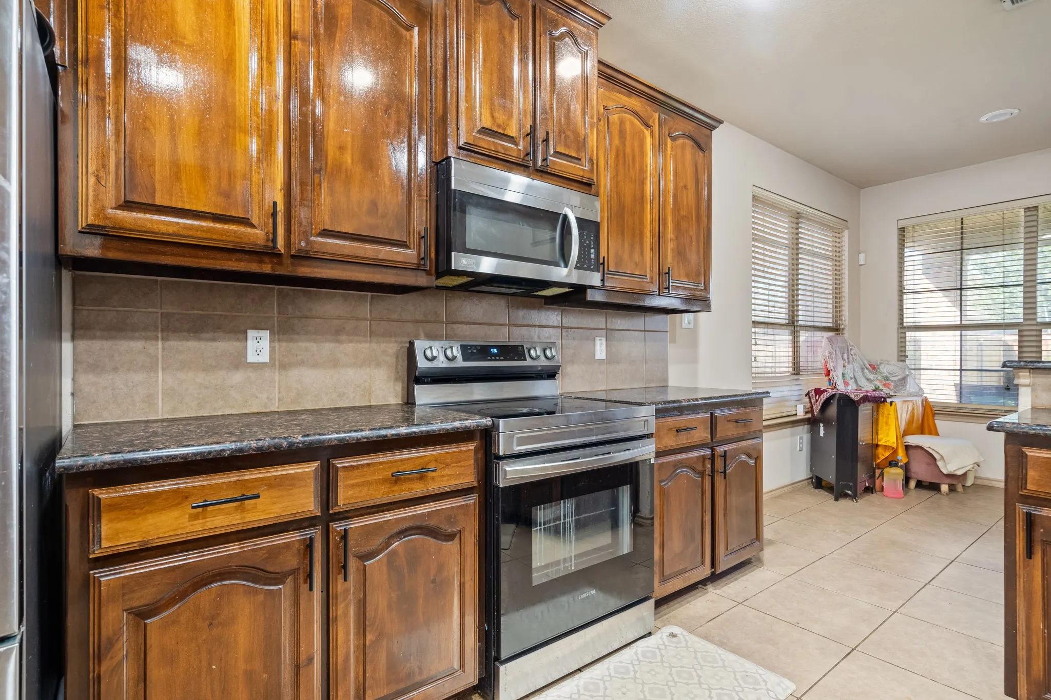 Kitchen with granite countertops, stainless steel appliances and ample cabinetry