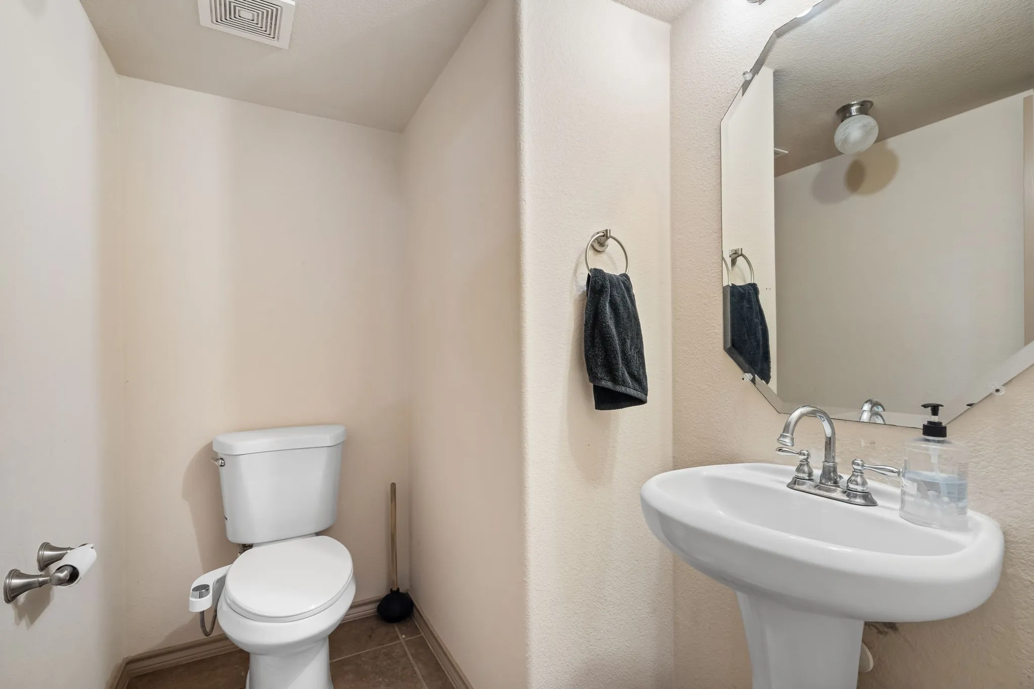 Half Bath downstairs next to the Living Room before entering the Primary Suite