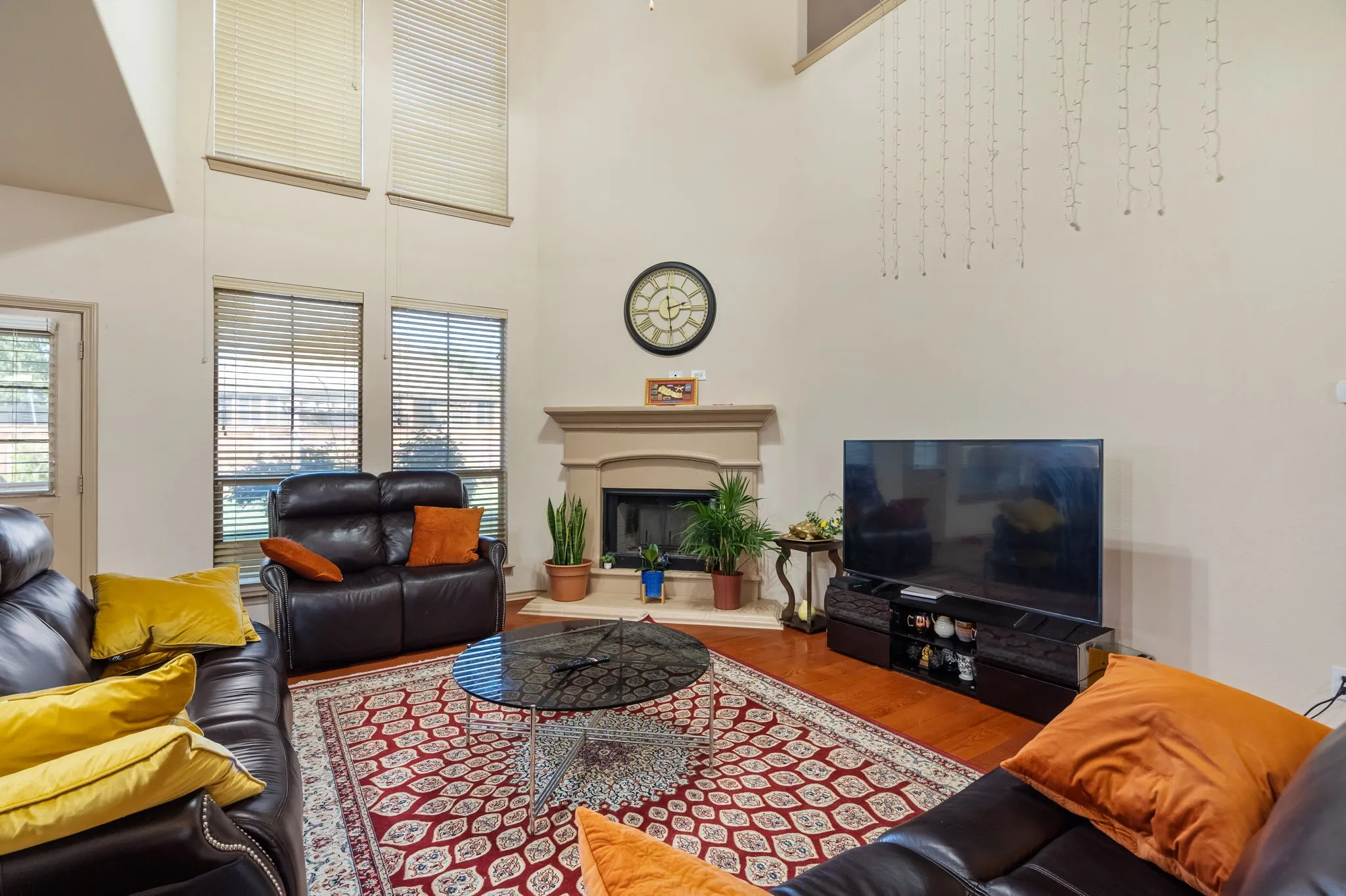 Living Room with 2-story ceiling, ceiling fan, lots of natural light, gas starter fireplace