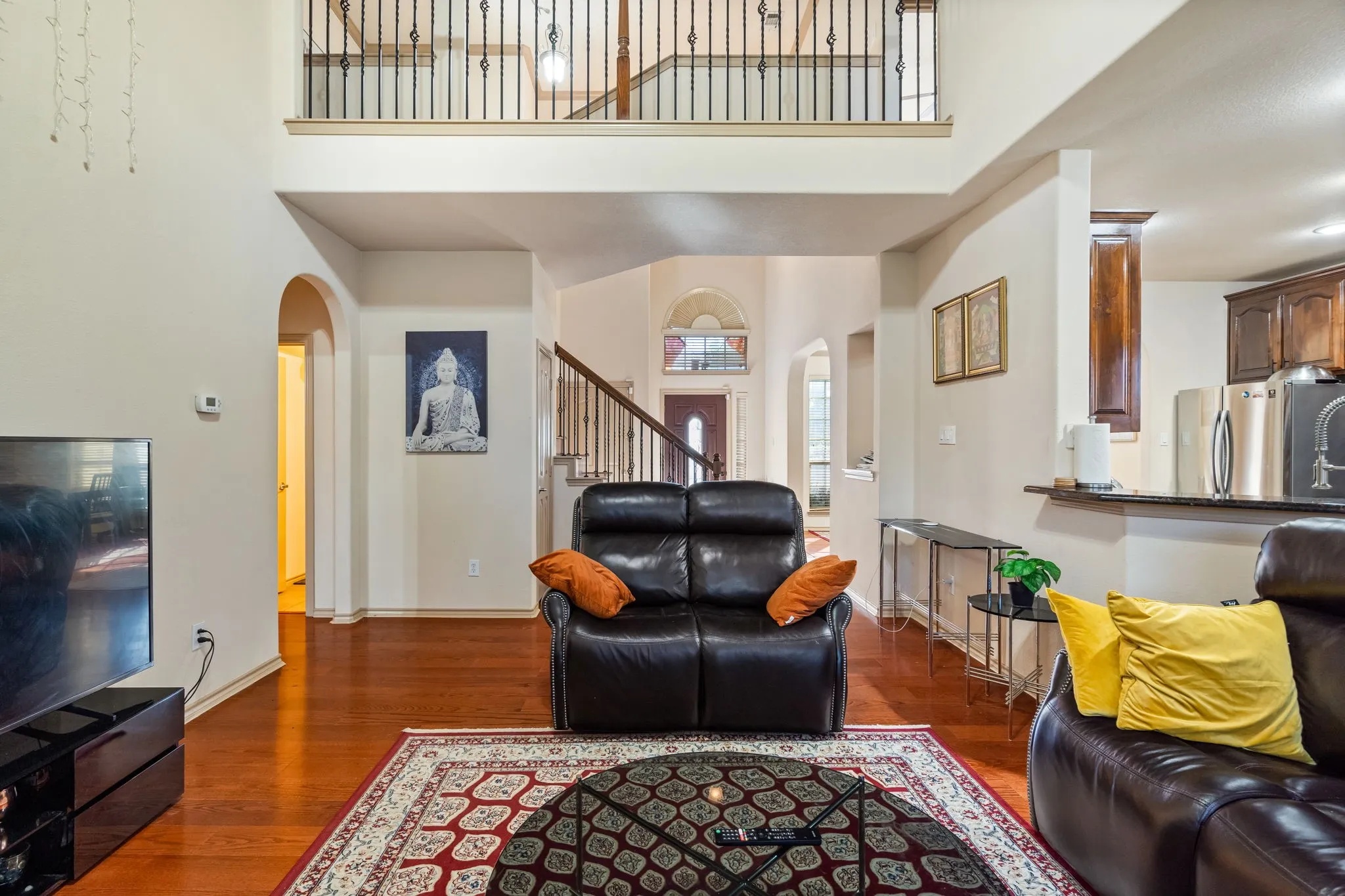 Living Room with 2-story ceiling, ceiling fan, lots of natural light, gas starter fireplace