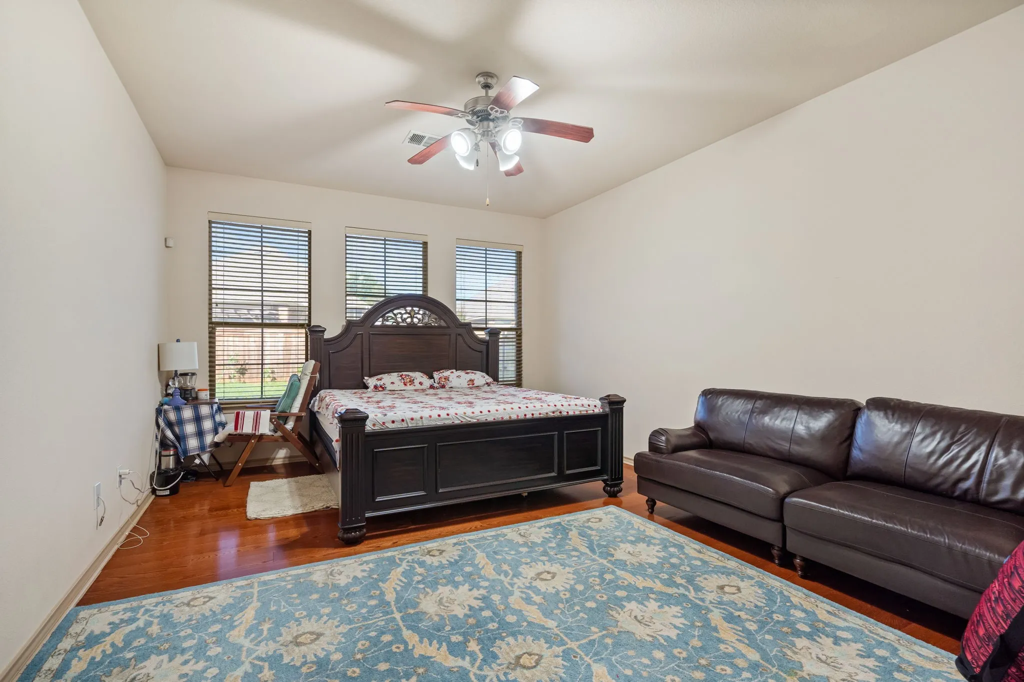 Primary Bedroom with lots of natural light and ceiling fan