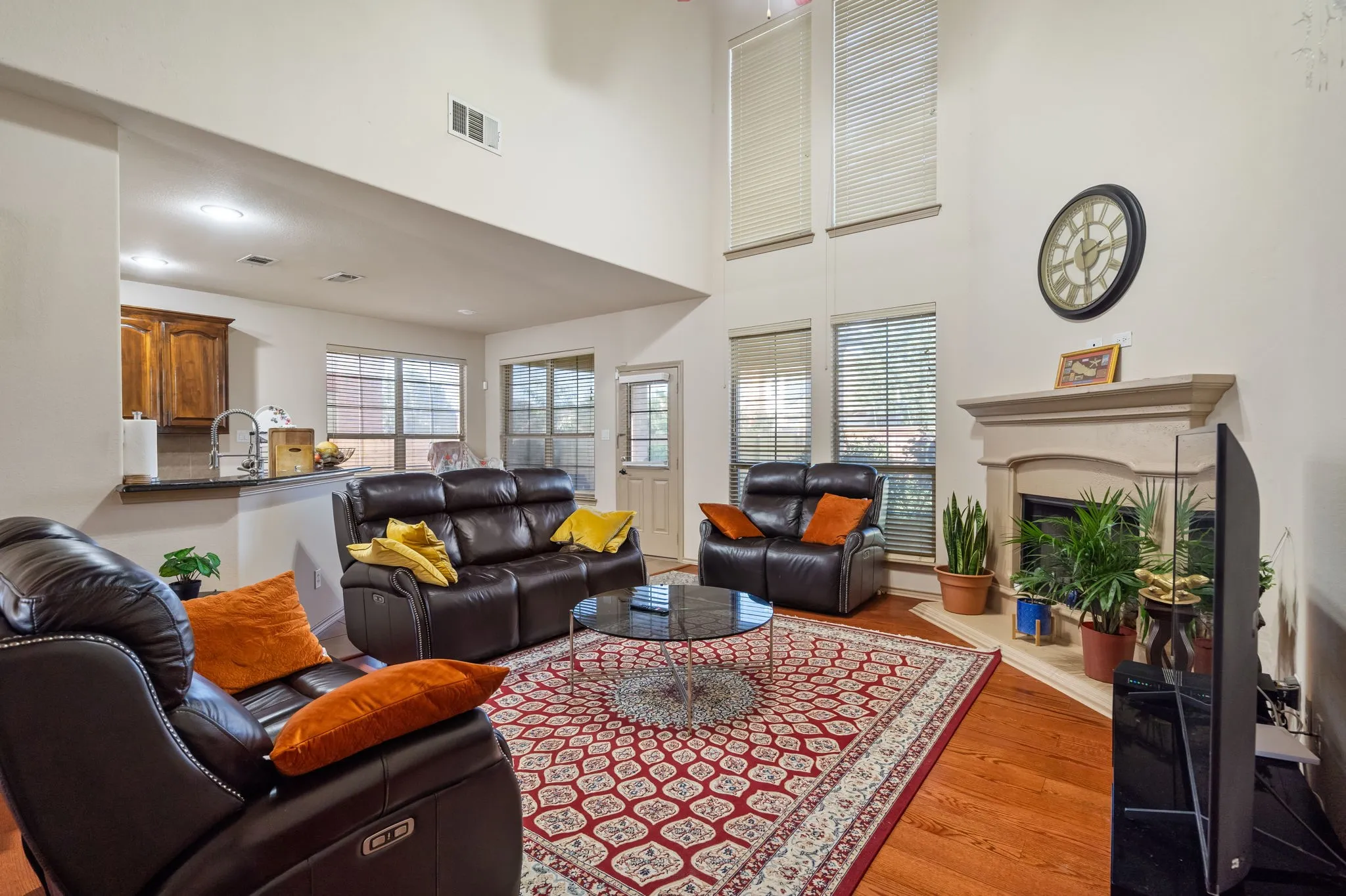 Living Room with 2-story ceiling, ceiling fan, lots of natural light, gas starter fireplace