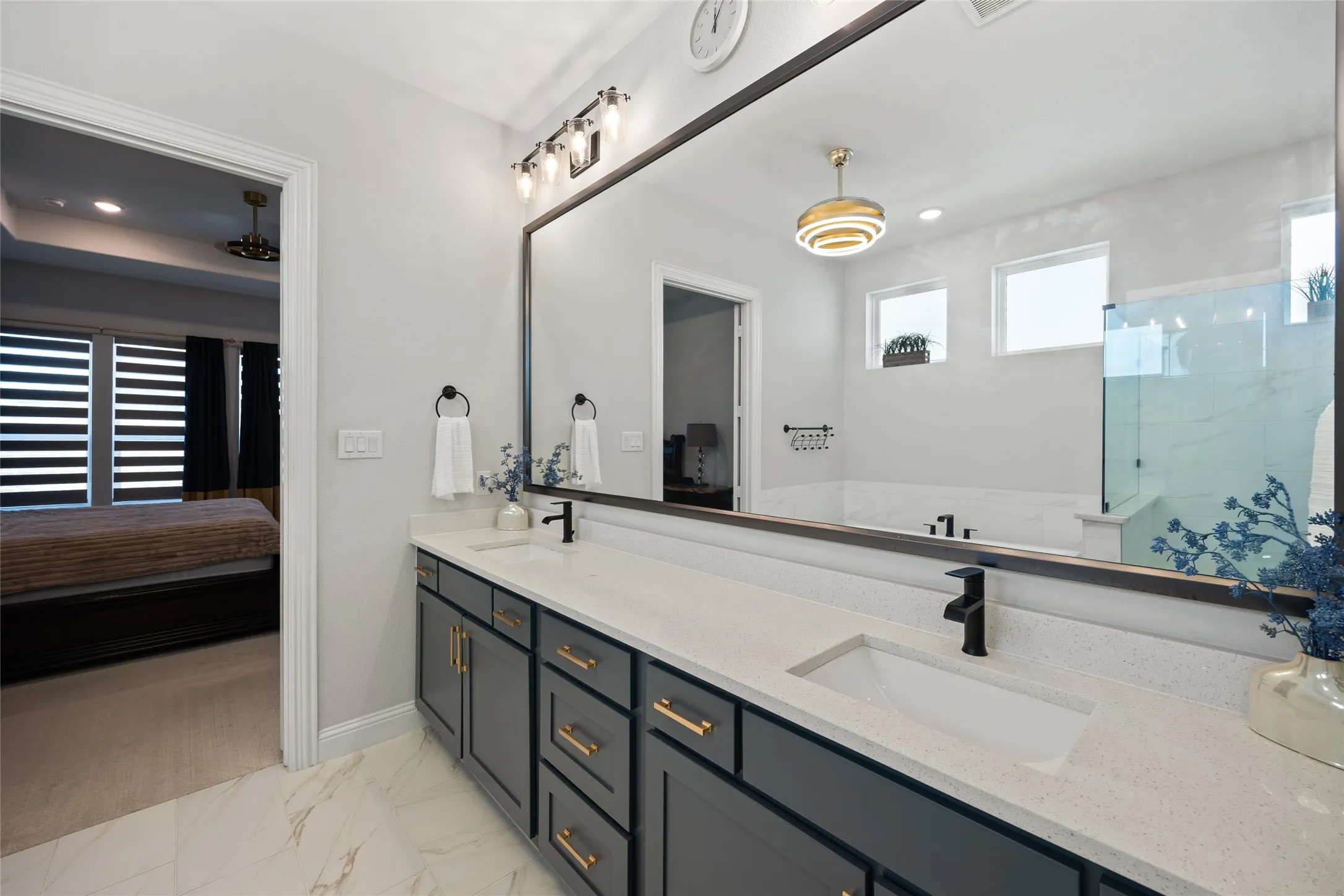 Dual vanity with stone-look countertop, undermount sinks, and matte black fixtures