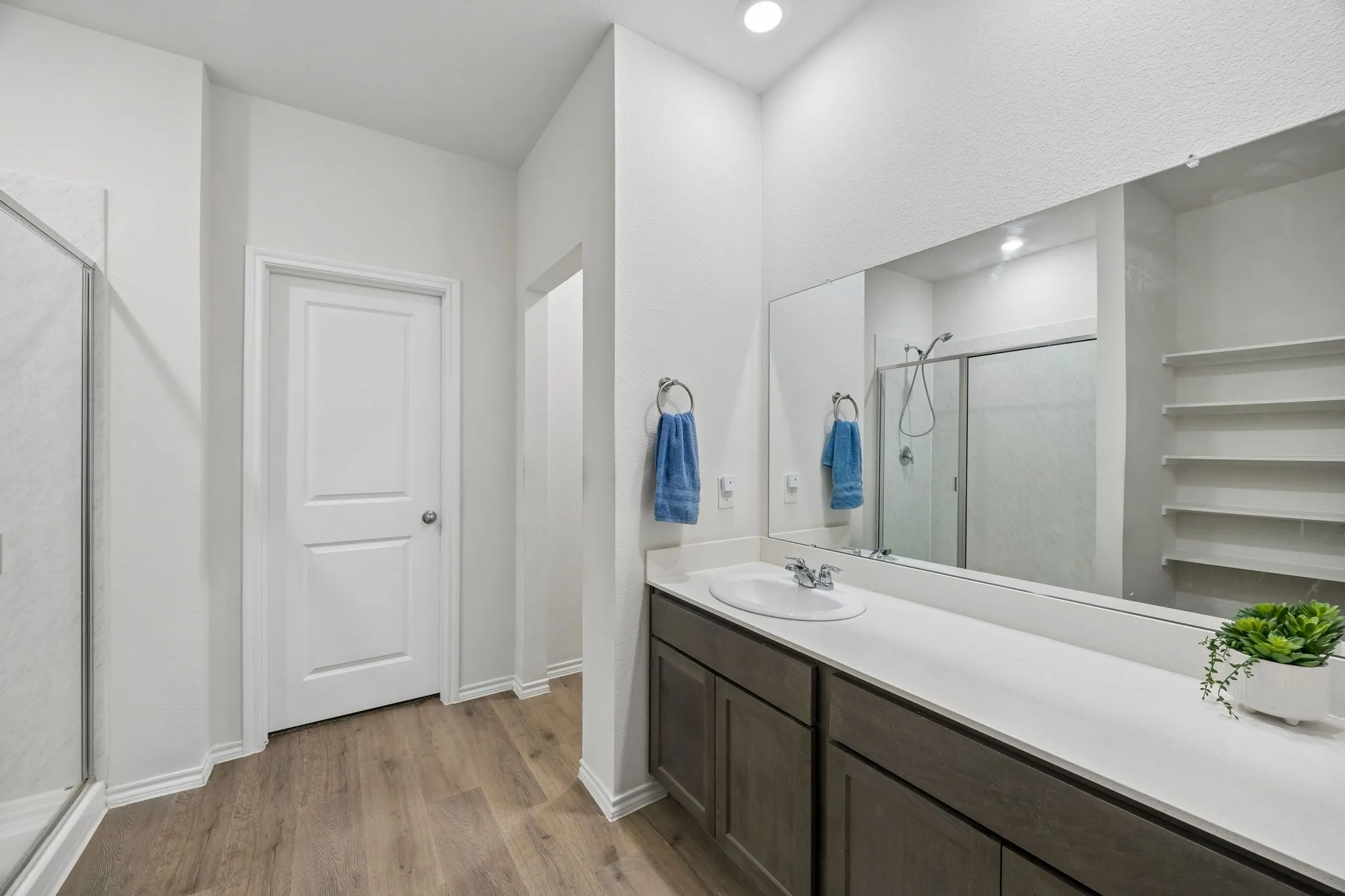 The ensuite primary bathroom features an oversized vanity.