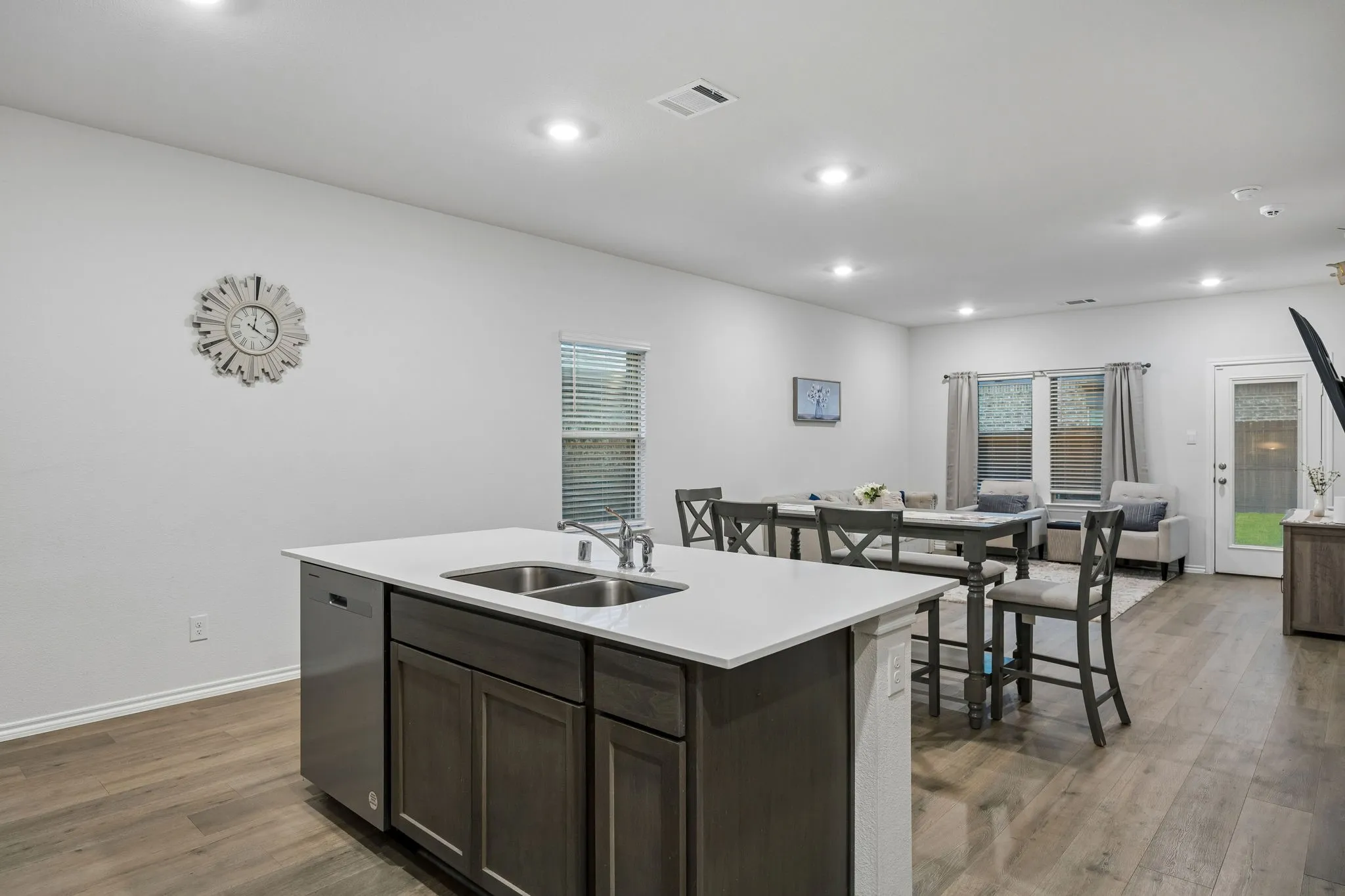 From the back of the kitchen looking into the open concept living space.