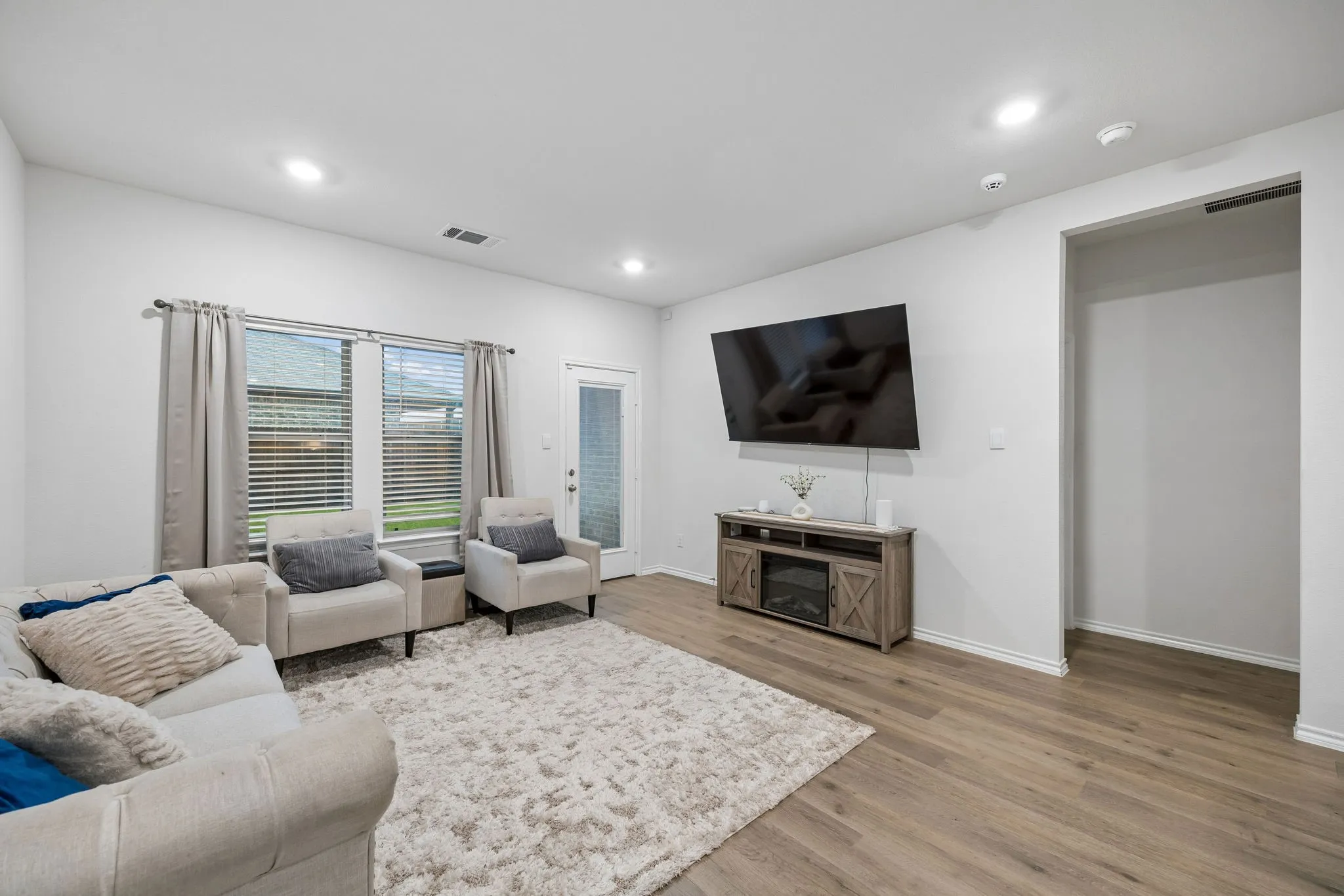 Another view of the living room and the oversized opening to the primary suite.