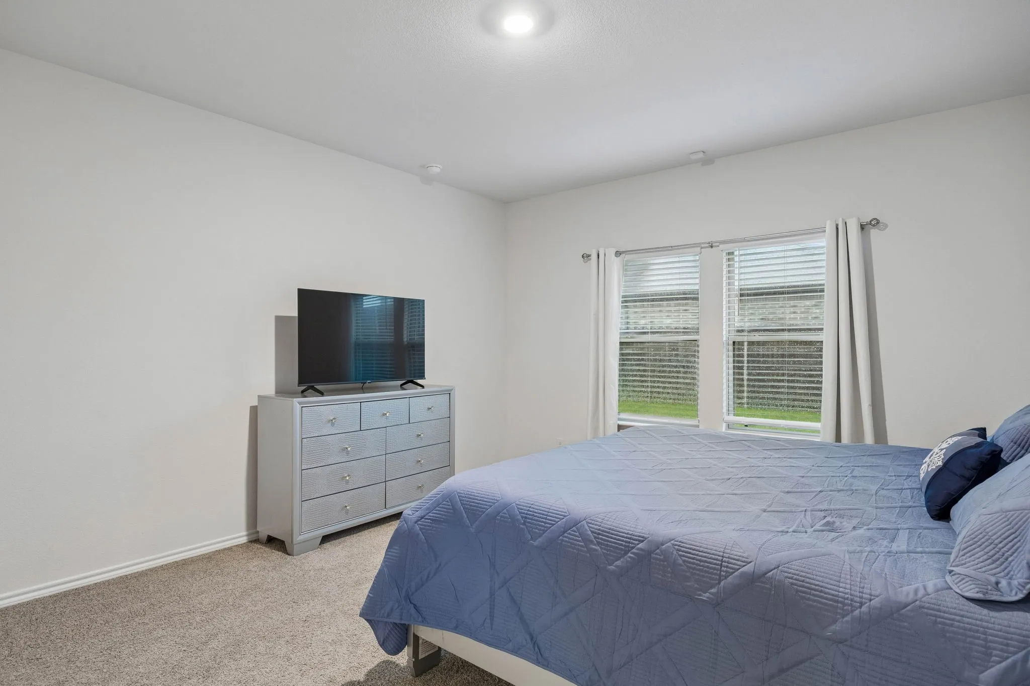 The primary suite is at the back of the home and features a great view of the back yard.