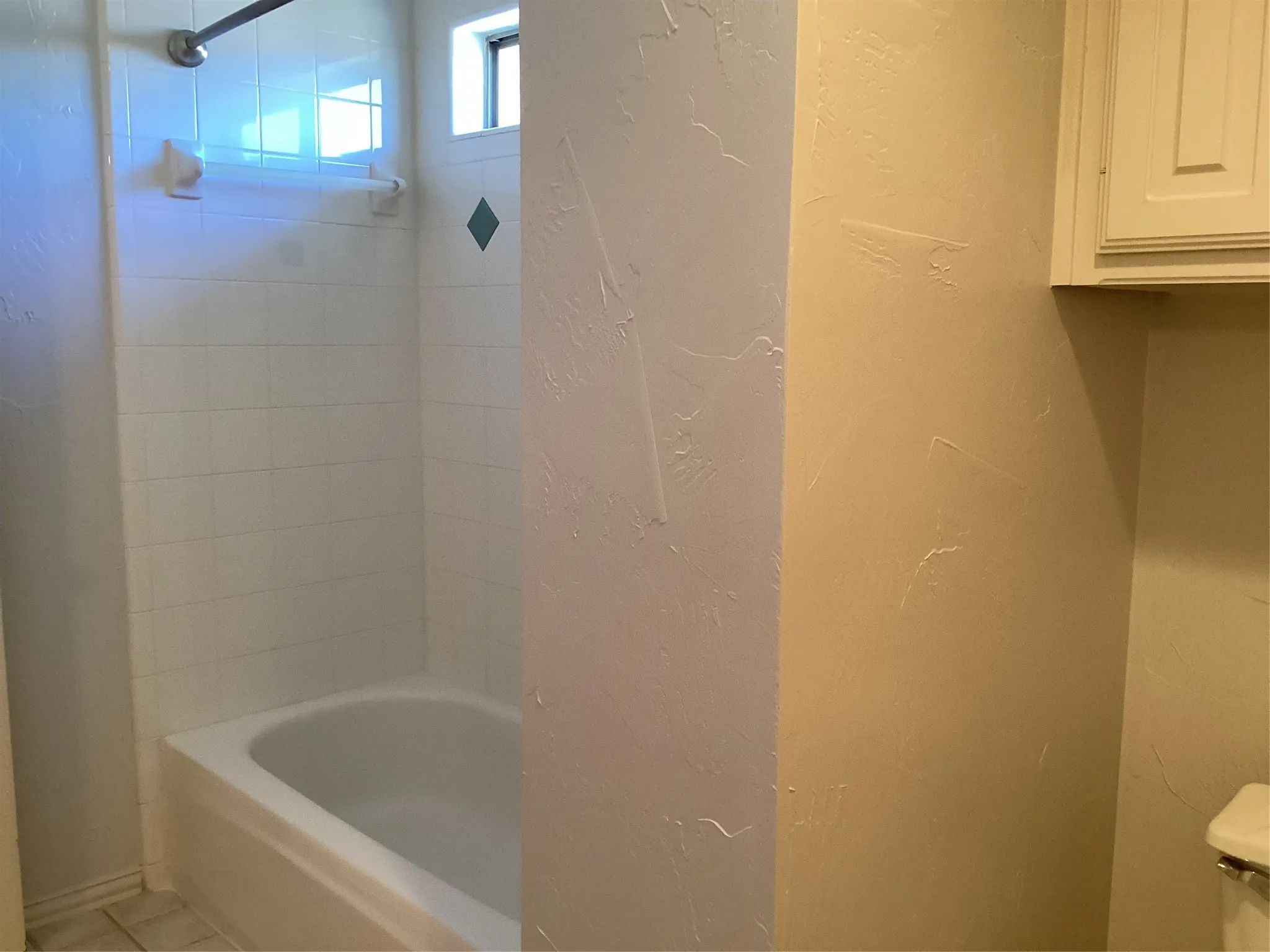 White subway tile shower surround with an integrated bathtub