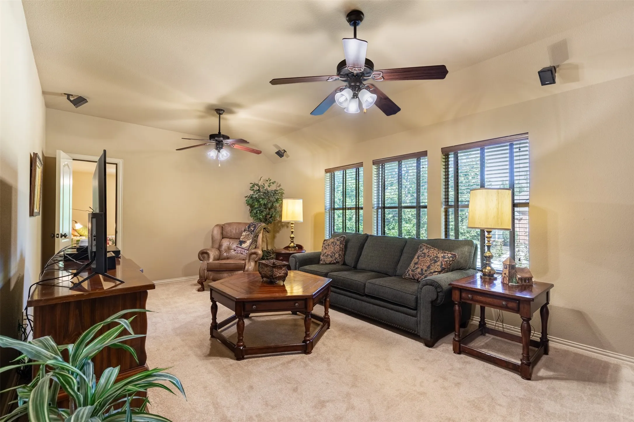 Upstairs game room with two ceiling fans.