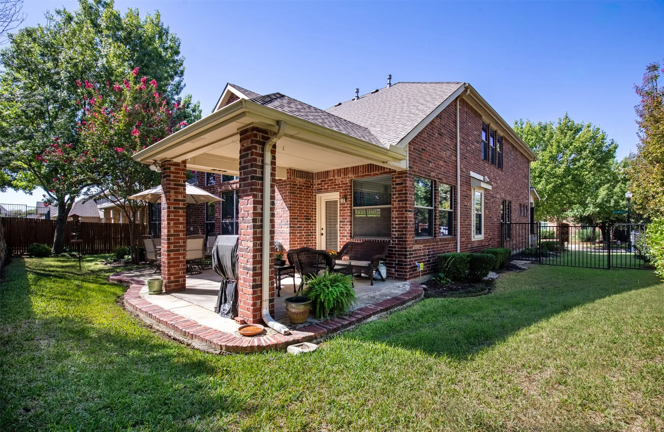 Back of home features grassy area with side yard.