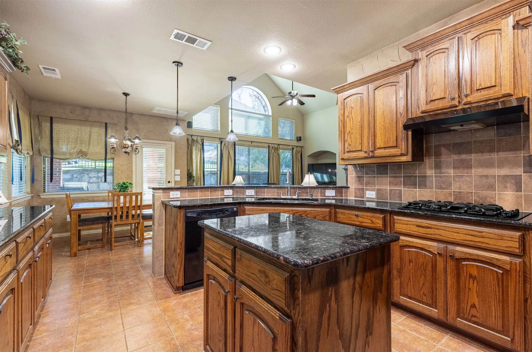 Kitchen features prep island with storage.