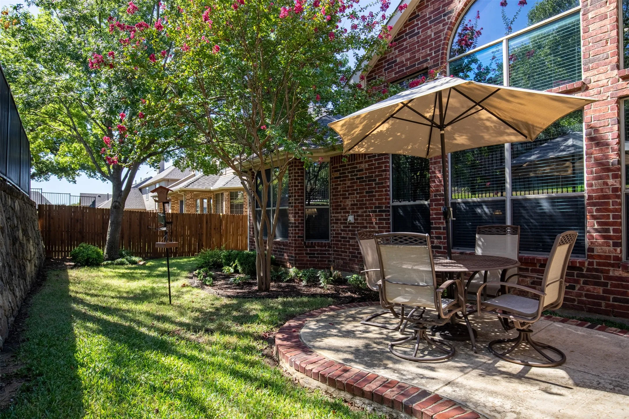 Backyard with shade trees and privacy fencing.