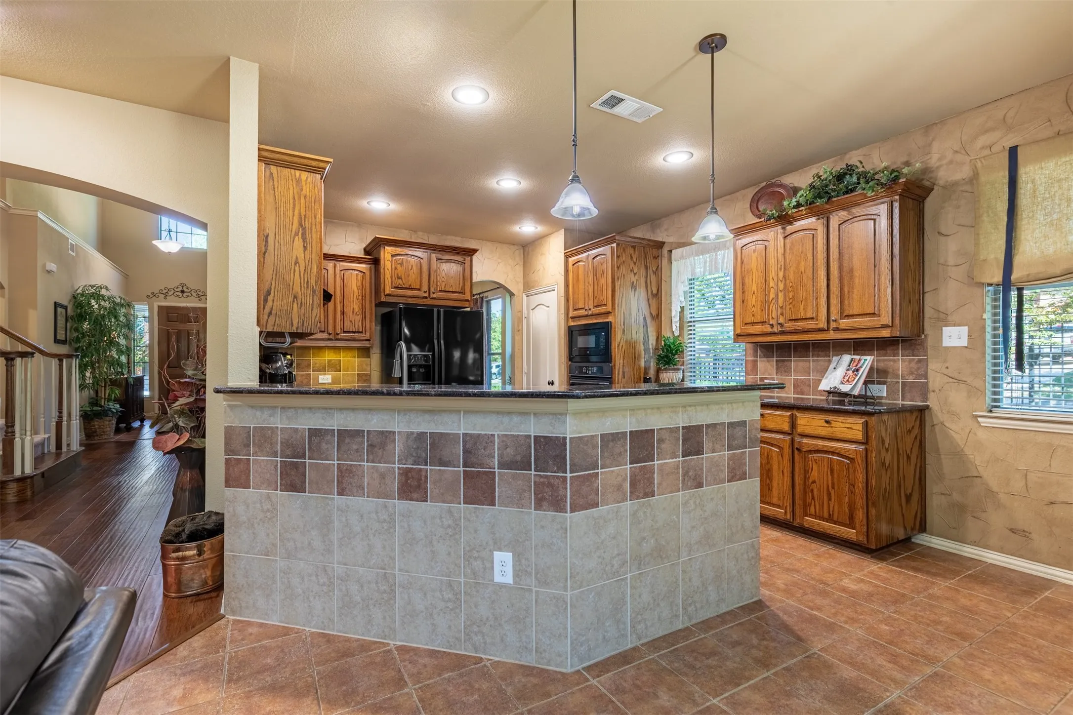 Gourmet kitchen with wrap around breakfast bar.