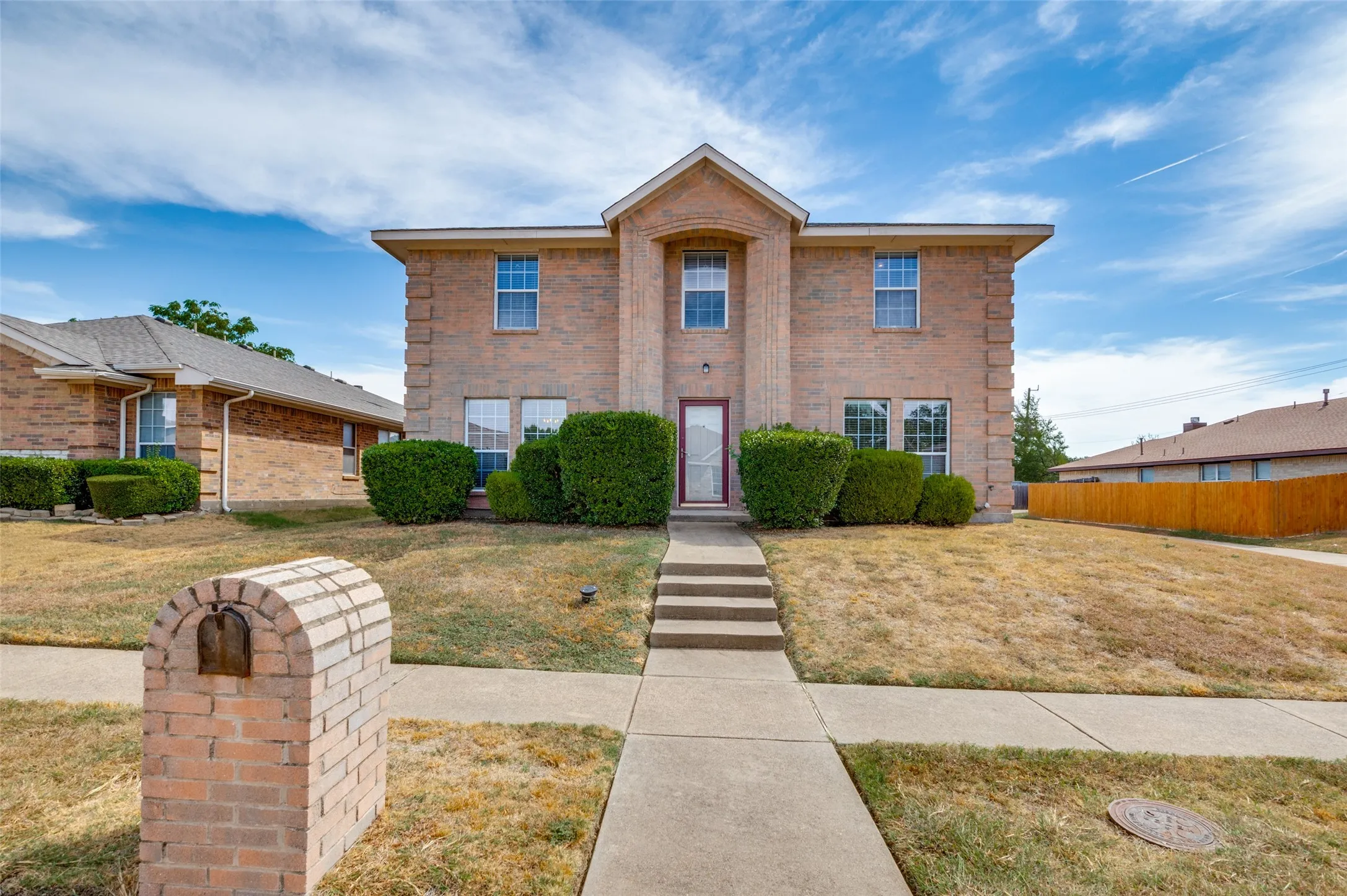 Brick two-story exterior with a centered entrance
