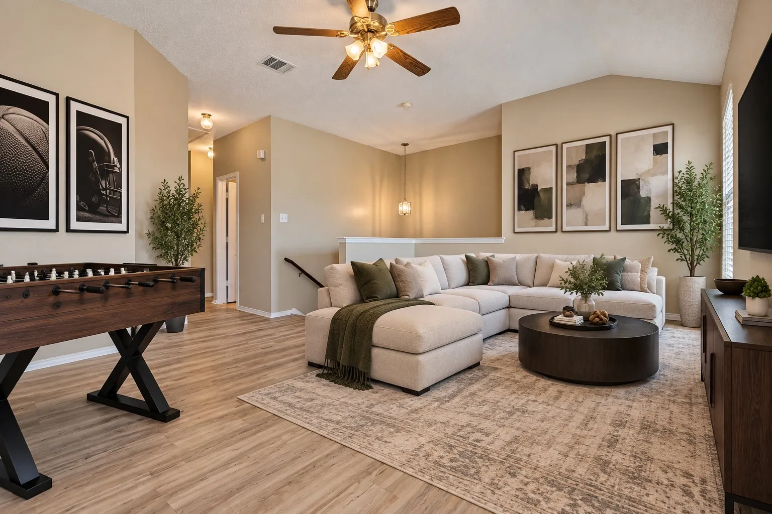 Vaulted ceiling with a ceiling fan, light wood-finish flooring, and an open-concept layout