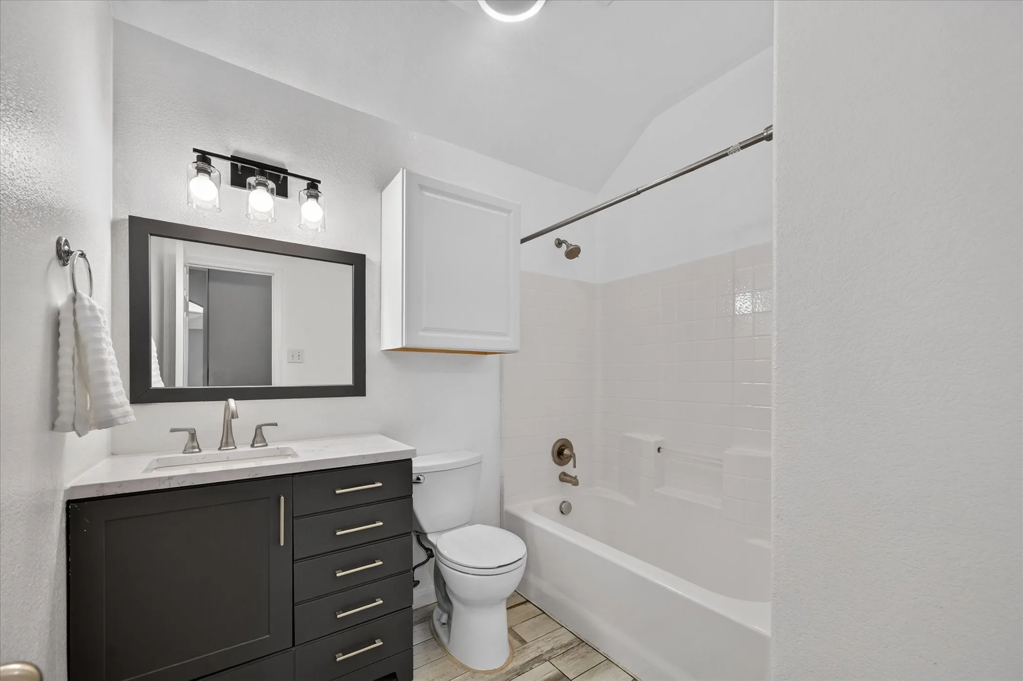 White tiled shower with a built-in tub