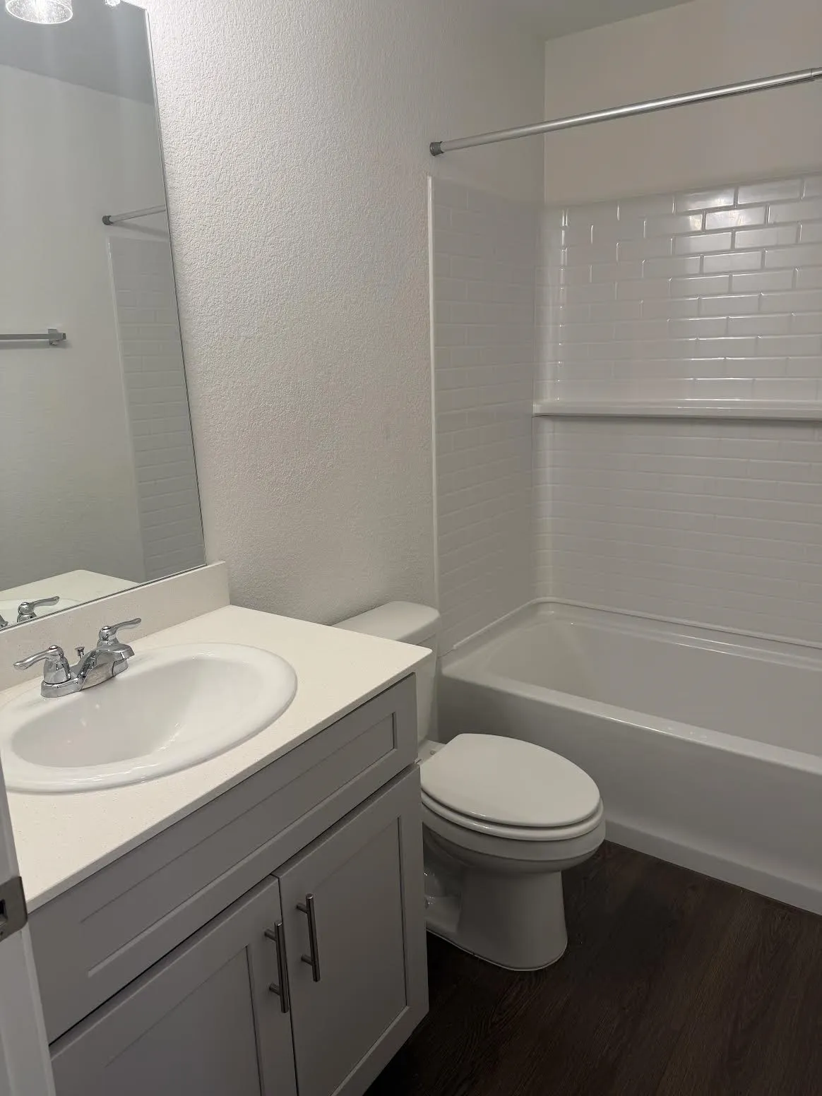 Vanity with integrated sink, white countertop, and gray shaker-style cabinetry