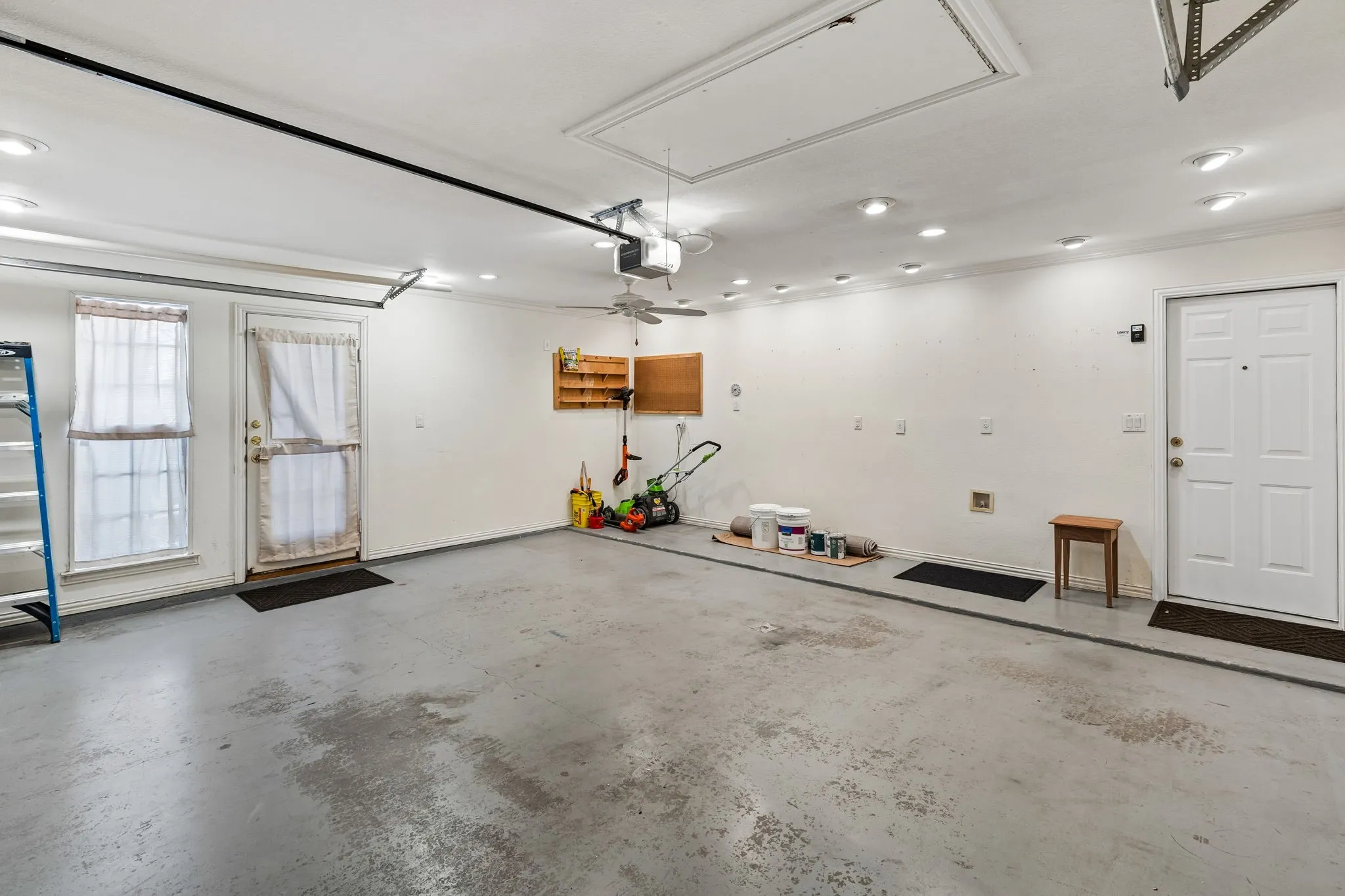 Garage has 220v connection, custom lighting, and door to side yard